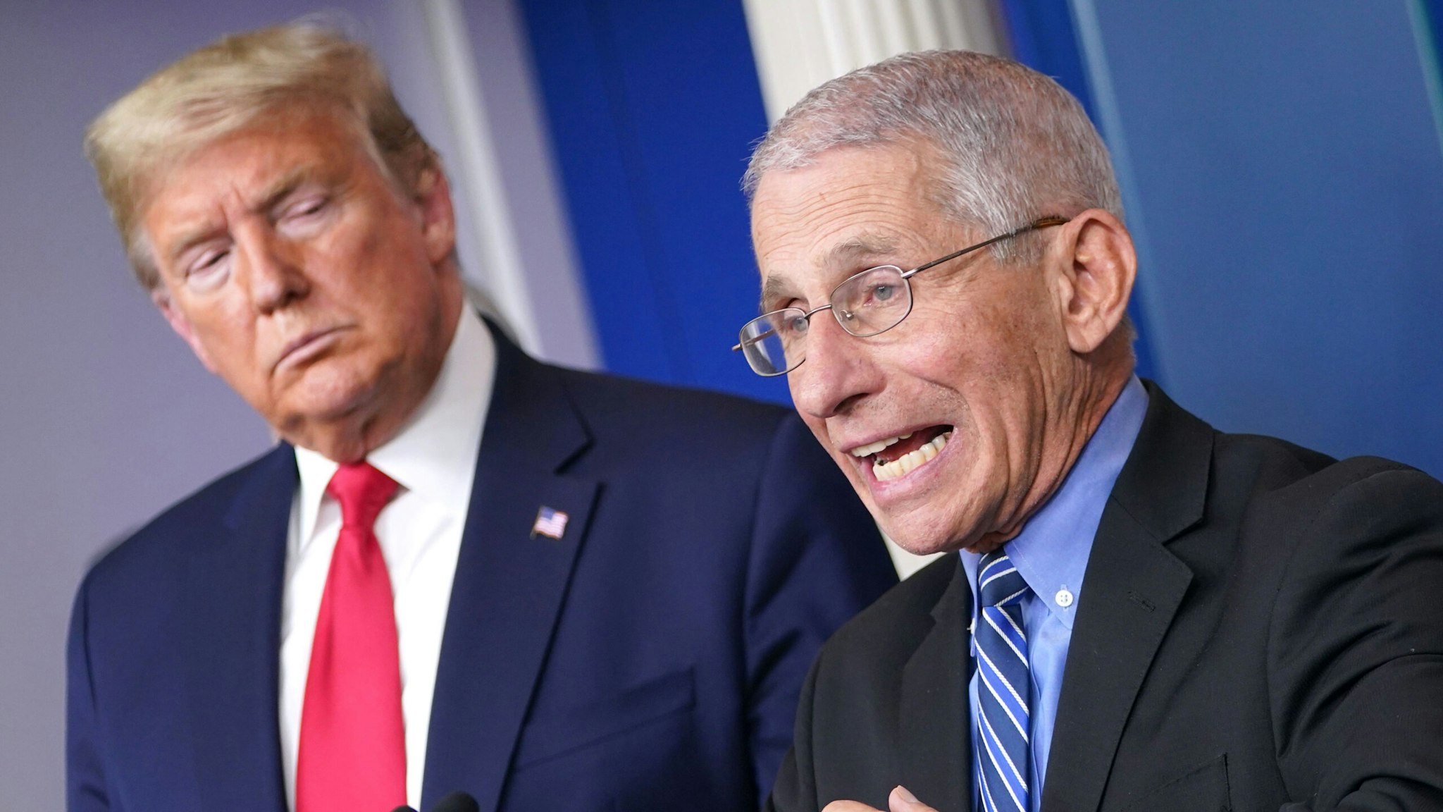 US President Donald Trump (L) listens as Director of the National Institute of Allergy and Infectious Diseases Anthony Fauci speaks during the daily briefing on the novel coronavirus, COVID-19, at the White House on March 24, 2020, in Washington, DC.