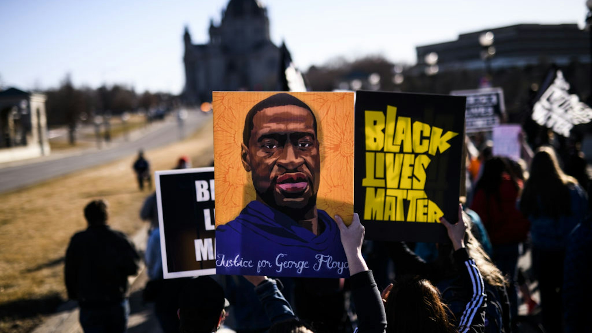 ST PAUL, MN - MARCH 19: People march near the Minnesota State Capitol to honor George Floyd on March 19, 2021 in St Paul, Minnesota. This morning Judge Peter Cahill rejected motions for change of venue and continuance by the defense of former Minneapolis Police officer Derek Chauvin, who is accused of killing George Floyd last May.
