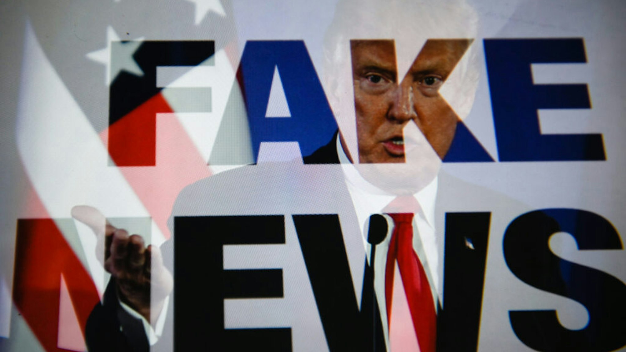 KRAKOW, POLAND - 2018/07/26: (EDITORS NOTE: This image has been altered: [Double exposure].) In this photo illustration a double exposure image shows the President of United States of America, Donald Trump with a sentence saying "Fake news".