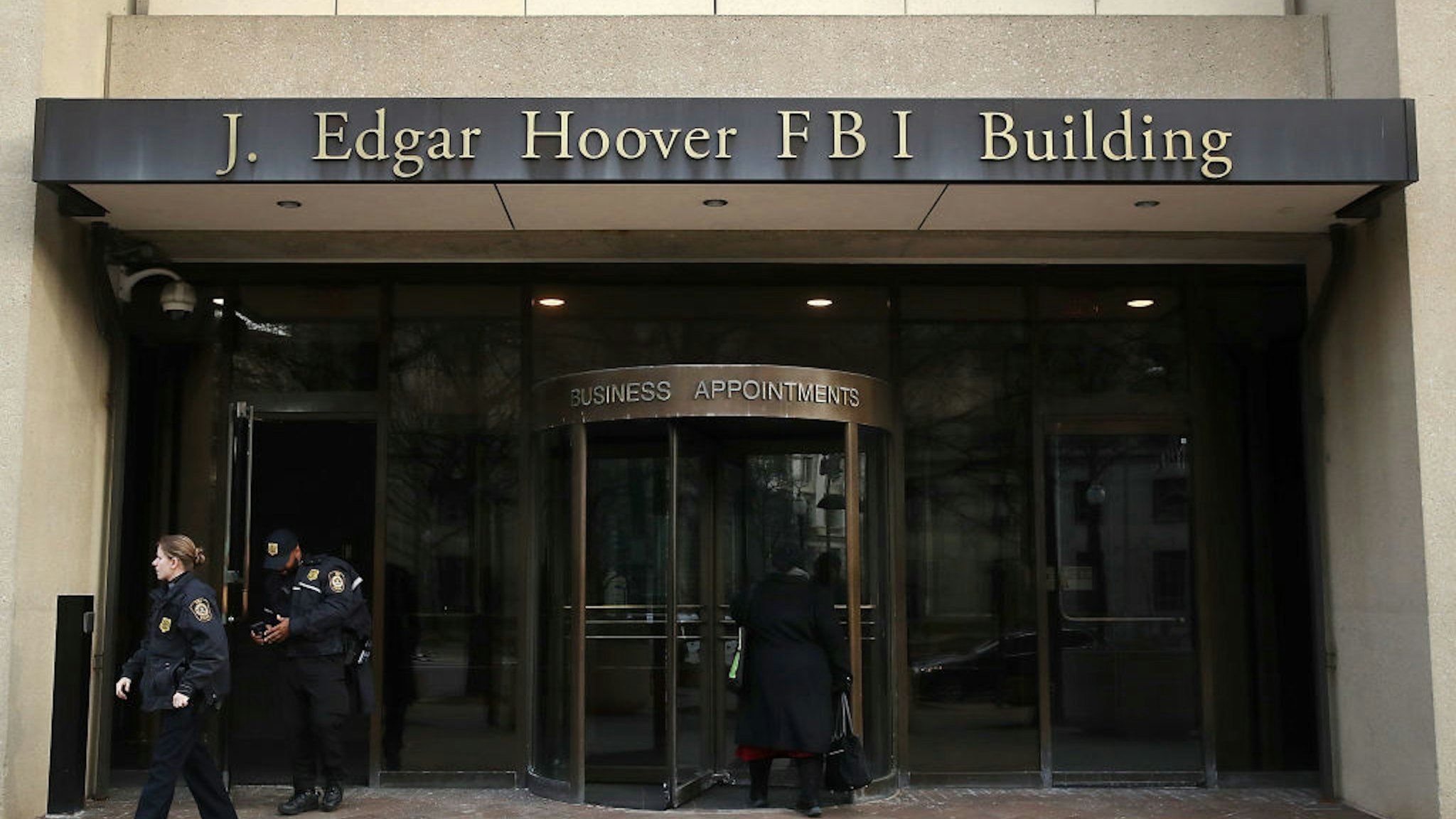 law enforcement officers walk out of the J. Edgar Hoover FBI Building on January 28, 2019 in Washington, DC.