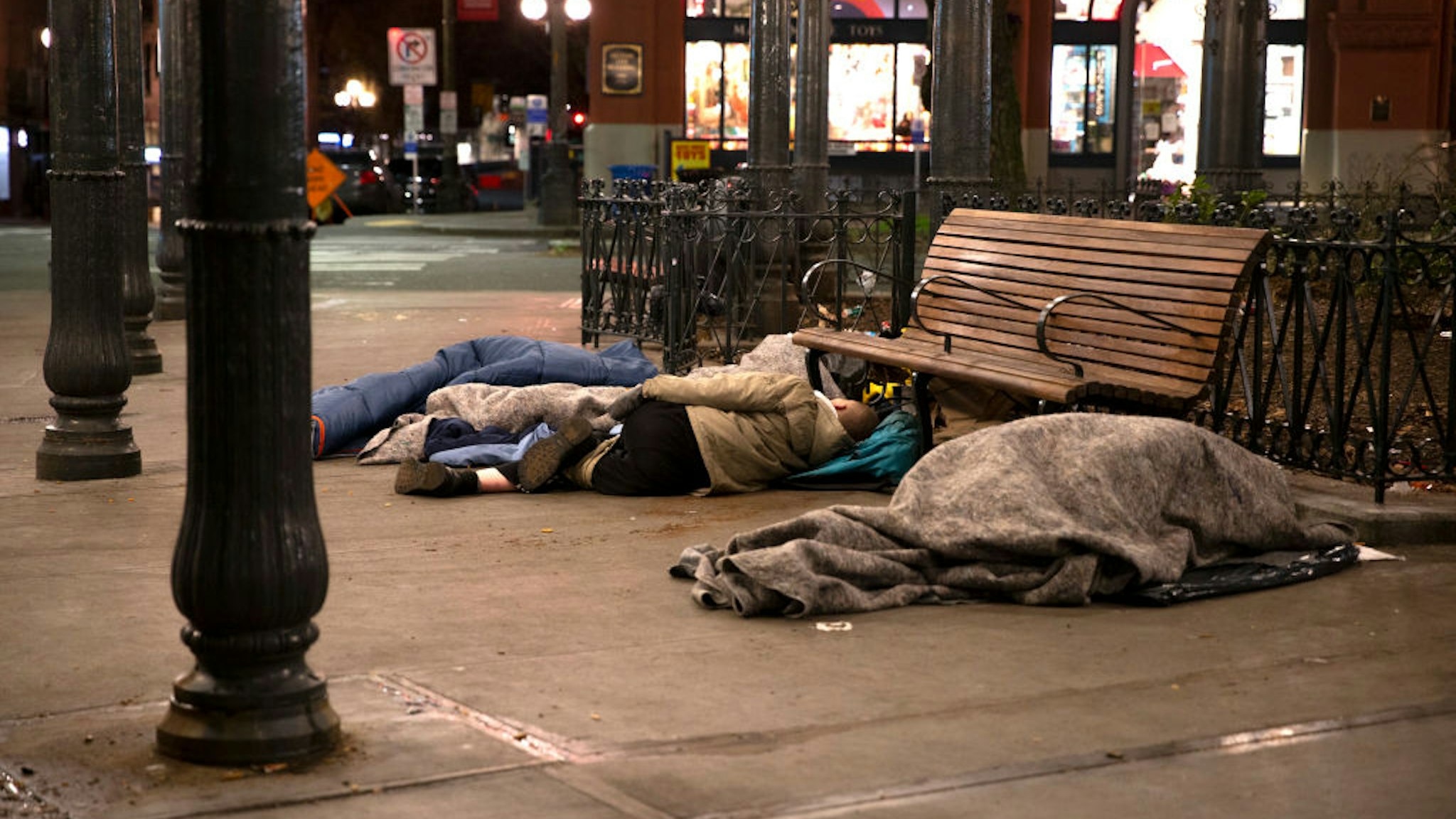 People sleep outside on a sidewalk on April 6, 2020 in Seattle, Washington.