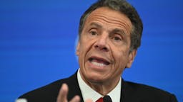 Andrew Cuomo Governor of New York Andrew Cuomo speaks during a press conference at the New York Stock Exchange (NYSE) on May 26, 2020 at Wall Street in New York City. - The New York Stock Exchange, the symbolic heart of Wall Street, reopened its floor Tuesday after a two-month closure due to the coronavirus, with traders donning masks and separated by plexiglas.Stocks surged at the outset of the session following the trademark opening bell, which was presided by New York Governor Andrew Cuomo and NYSE officials -- all donning masks.