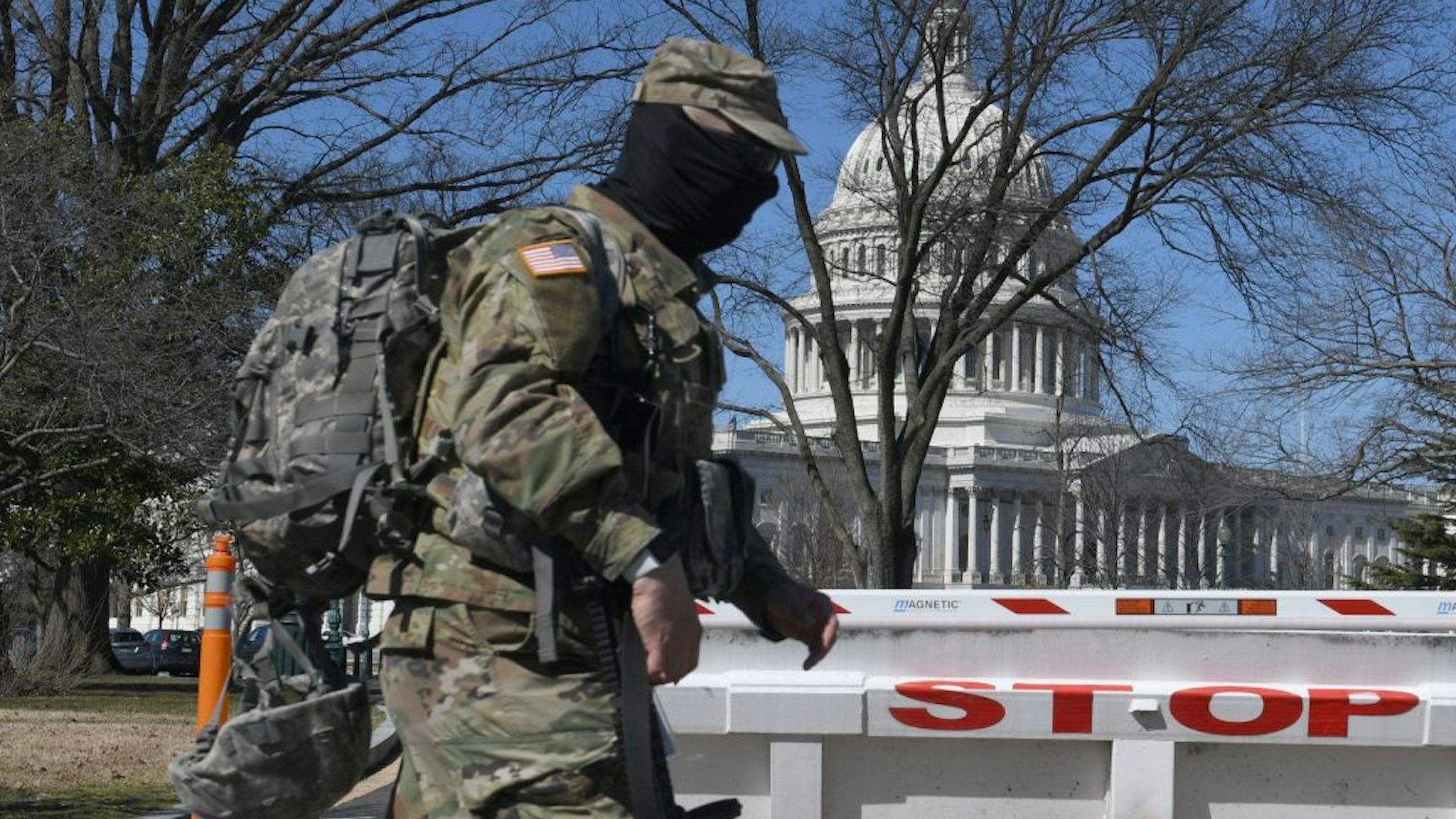 A members of the National Guard walks near the US Capitol Building on Capitol Hill March 3, 2021, in Washington, DC.
