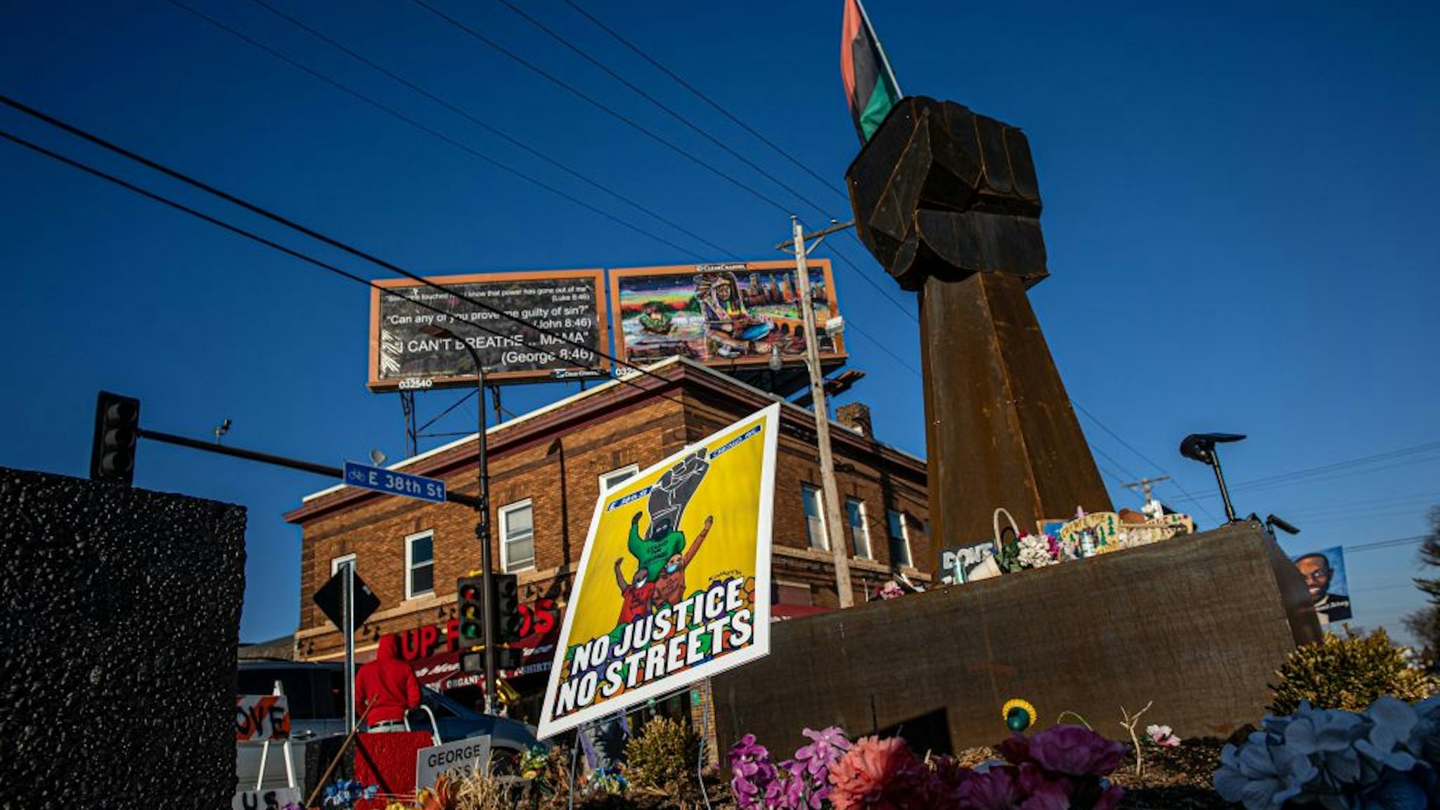 A sculpture of a raised fist stands near a makeshift memorial to George Floyd near the site where he died in police custody, on March 12, 2021 in Minneapolis, Minnesota. - The Minnesota city of Minneapolis reached a $27 million "wrongful death" settlement on March 12y with the family of George Floyd, the Black man who died while being arrested by a white police officer, sparking mass protests for racial justice across the United States. (Photo by Kerem Yucel / AFP) (Photo by KEREM YUCEL/AFP via Getty Images)