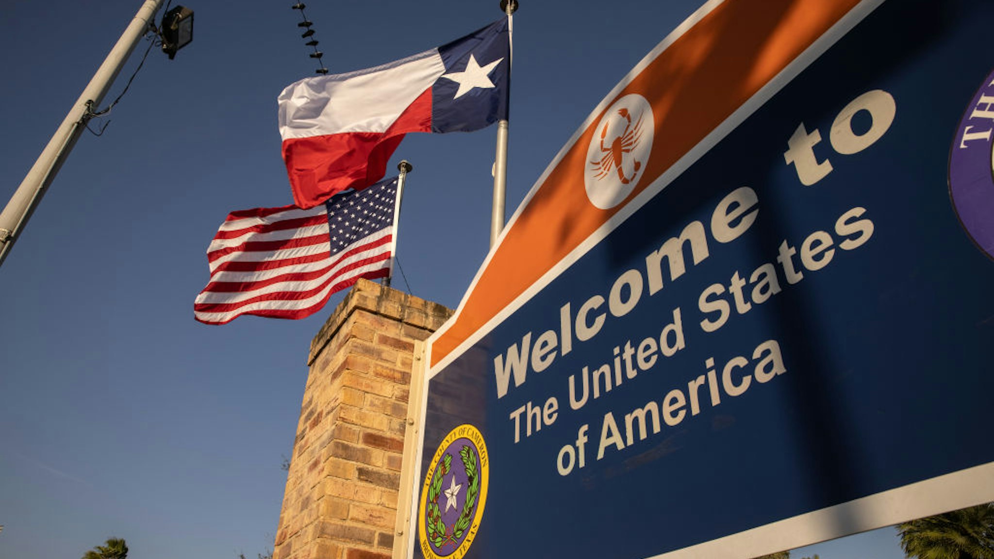 ROWNSVILLE, TEXAS - FEBRUARY 24: The U.S. and Texas flags fly near the U.S.-Mexico border on February 24, 2021 in Brownsville, Texas. (Photo by John Moore/Getty Images)