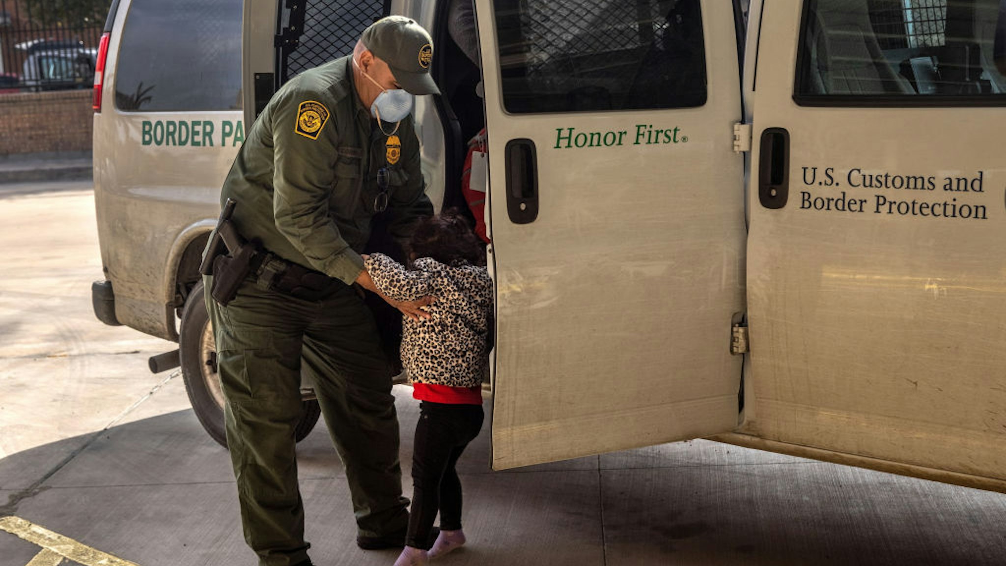 BROWNSVILLE, TEXAS - FEBRUARY 25: A U.S. Border Patrol agent releases a young asylum seeker with her family at a bus station on February 25, 2021 in Brownsville, Texas. U.S. immigration authorities are now releasing asylum seeking families after they cross the U.S.-Mexico border and taken into custody. The immigrant families are then free to travel to destinations throughout the U.S. while awaiting asylum hearings. (Photo by John Moore/Getty Images)
