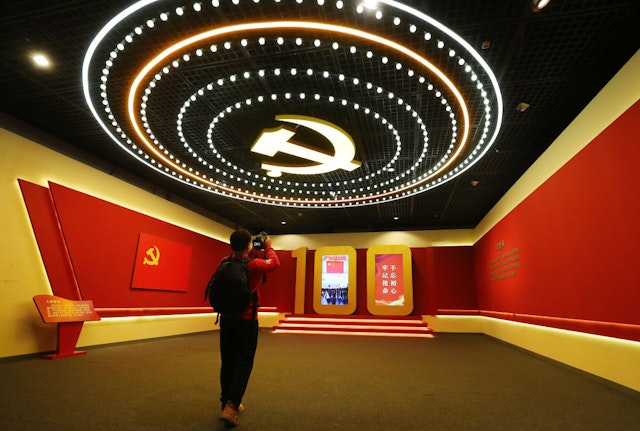 A visitor watches an exhibition commemorating the 100th anniversary of the founding of the Communist Party of China (CPC) at the Beijing Capital Museum on March 9, 2021 in Beijing, China.
