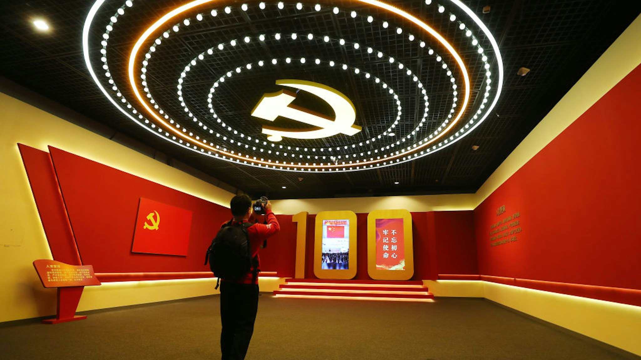 A visitor watches an exhibition commemorating the 100th anniversary of the founding of the Communist Party of China (CPC) at the Beijing Capital Museum on March 9, 2021 in Beijing, China.