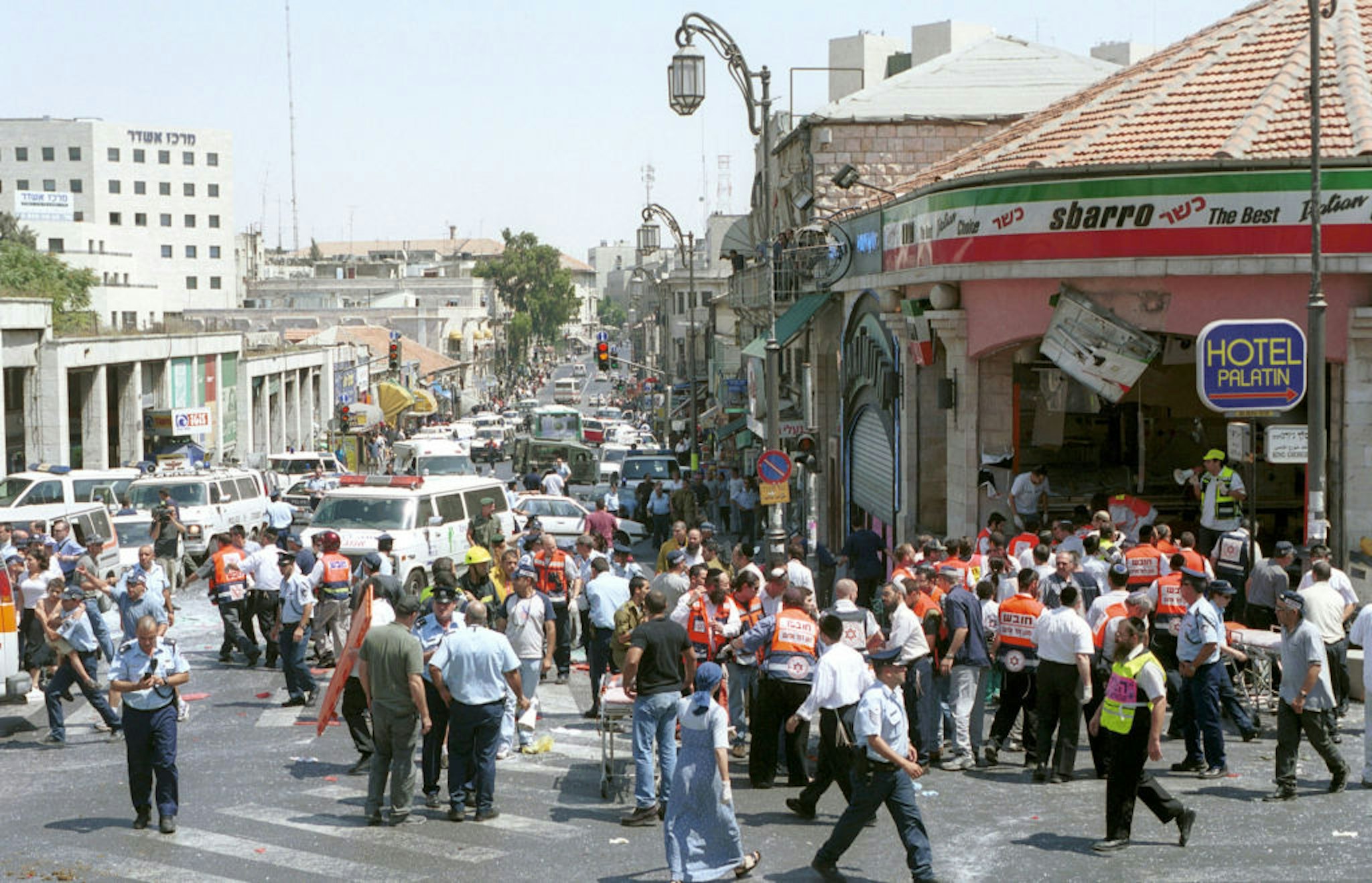 Israeli medics and volunteers treat the injured at the site of a Palestinian suicide bombing August 9, 2001 in Jerusalem, Israel.
