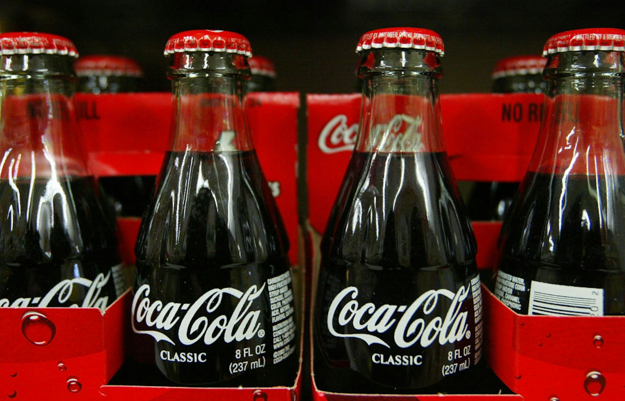 SAN FRANCISCO - JANUARY 16: Bottles of Coca-Cola are seen on the shelf at Tower Market January 16, 2004 in San Francisco, California. Coca-Cola is being investigated by U.S. regulators over allegations raised by a former employee that it had inflated its earnings.