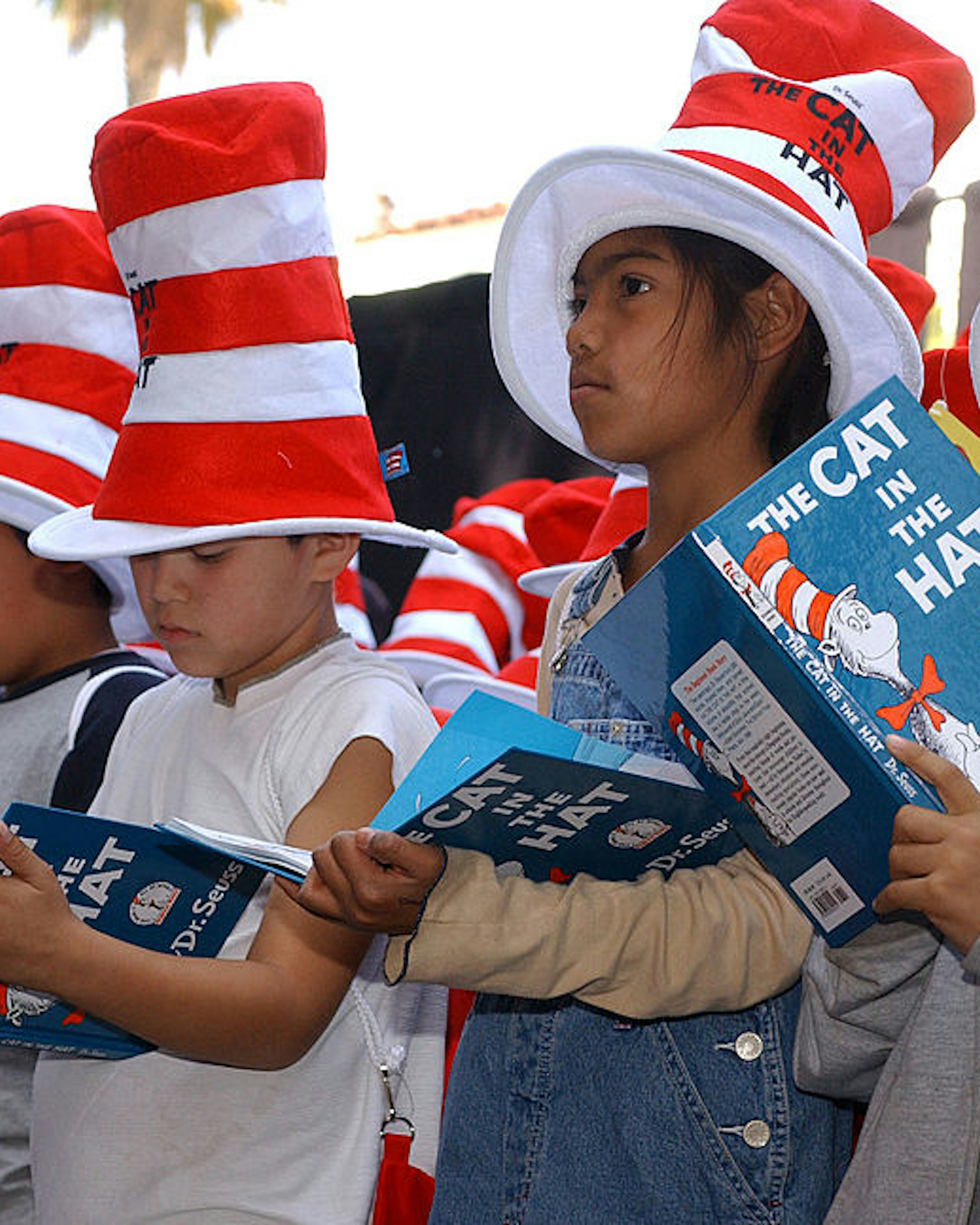 HOLLYWOOD - MARCH 11: Children read from "The Cat in the Hat" book at a ceremony honoring the late children's book author Dr. Seuss (Theodore Geisel) with a star on the Hollywood Walk of Fame on March 11, 2004 in Hollywood , California. (Photo by Vince Bucci/Getty Images)