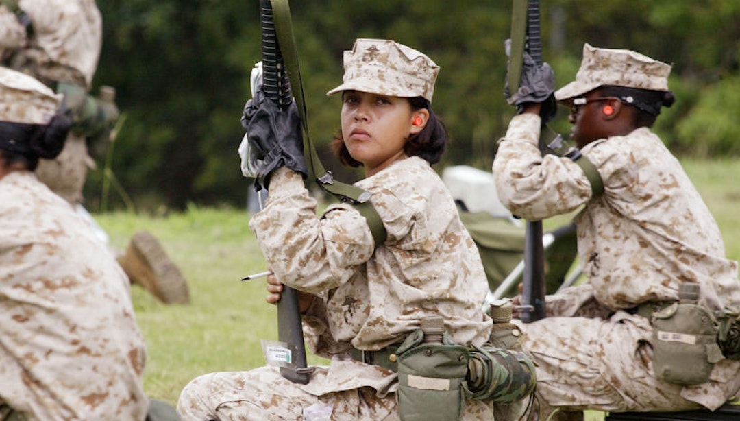 PARRIS ISLAND, SC - JUNE 21: Female Marine Corps recruits wait for a turn to shoot on the rifle range at the United States Marine Corps recruit depot June 21, 2004 in Parris Island, South Carolina. Marine Corps boot camp, with its combination of strict discipline and exhaustive physical training, is considered the most rigorous of the armed forces recruit training. Congress is currently considering bills that could increase the size of the Marine Corps and the Army to help meet US military demands in Iraq and Afghanistan. (Photo by Scott Olson/Getty Images)