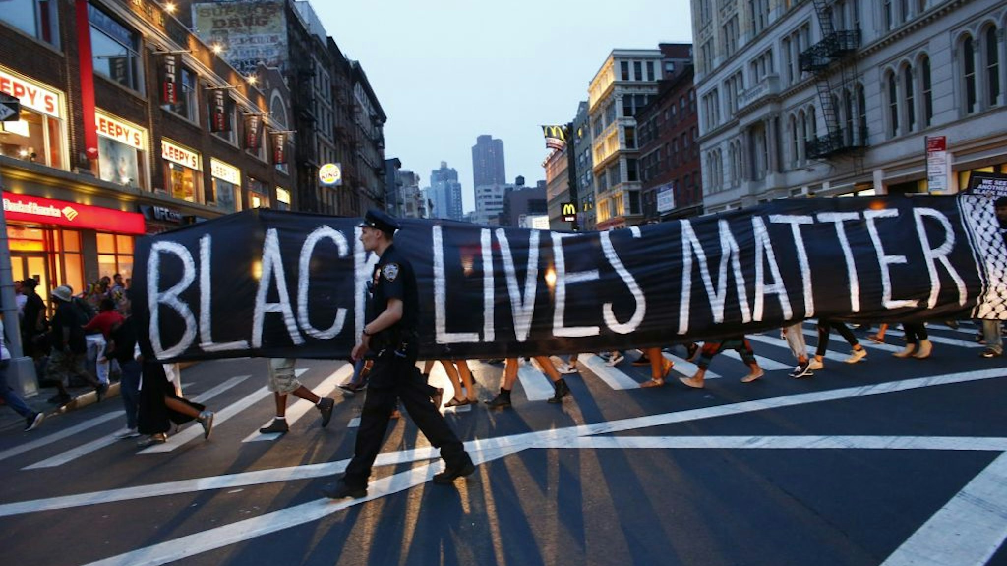 TOPSHOT - A police officer patrols during a protest in support of the Black lives matter movement in New York on July 09, 2016. - The gunman behind a sniper-style attack in Dallas was an Army veteran and loner driven to exact revenge on white officers after the recent deaths of two black men at the hands of police, authorities have said. Micah Johnson, 25, had no criminal history, Dallas police said in a statement. (Photo by KENA BETANCUR / AFP) (Photo by KENA BETANCUR/AFP via Getty Images)
