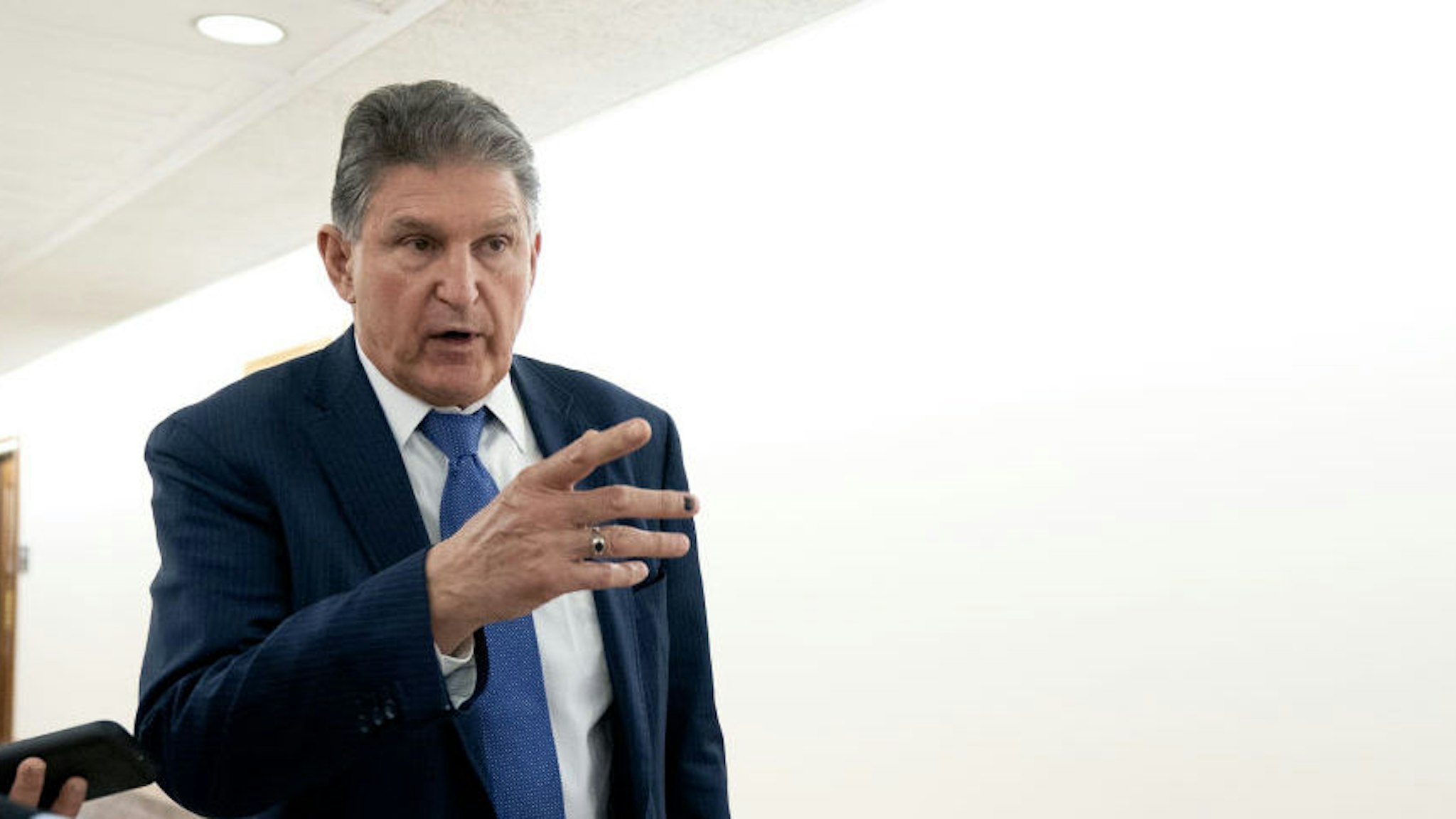 Senator Joe Manchin, a Democrat from West Virginia, speaks to members of the media while departing a bipartisan Senate luncheon in Dirksen Senate Office Building in Washington, D.C., U.S., on Wednesday, March 3, 2021. President Biden's imperative of swiftly passing his $1.9 trillion pandemic-relief program faces one of its final hurdles, settling disputes among Senate Democrats over how to ensure aid gets to those who truly need it.