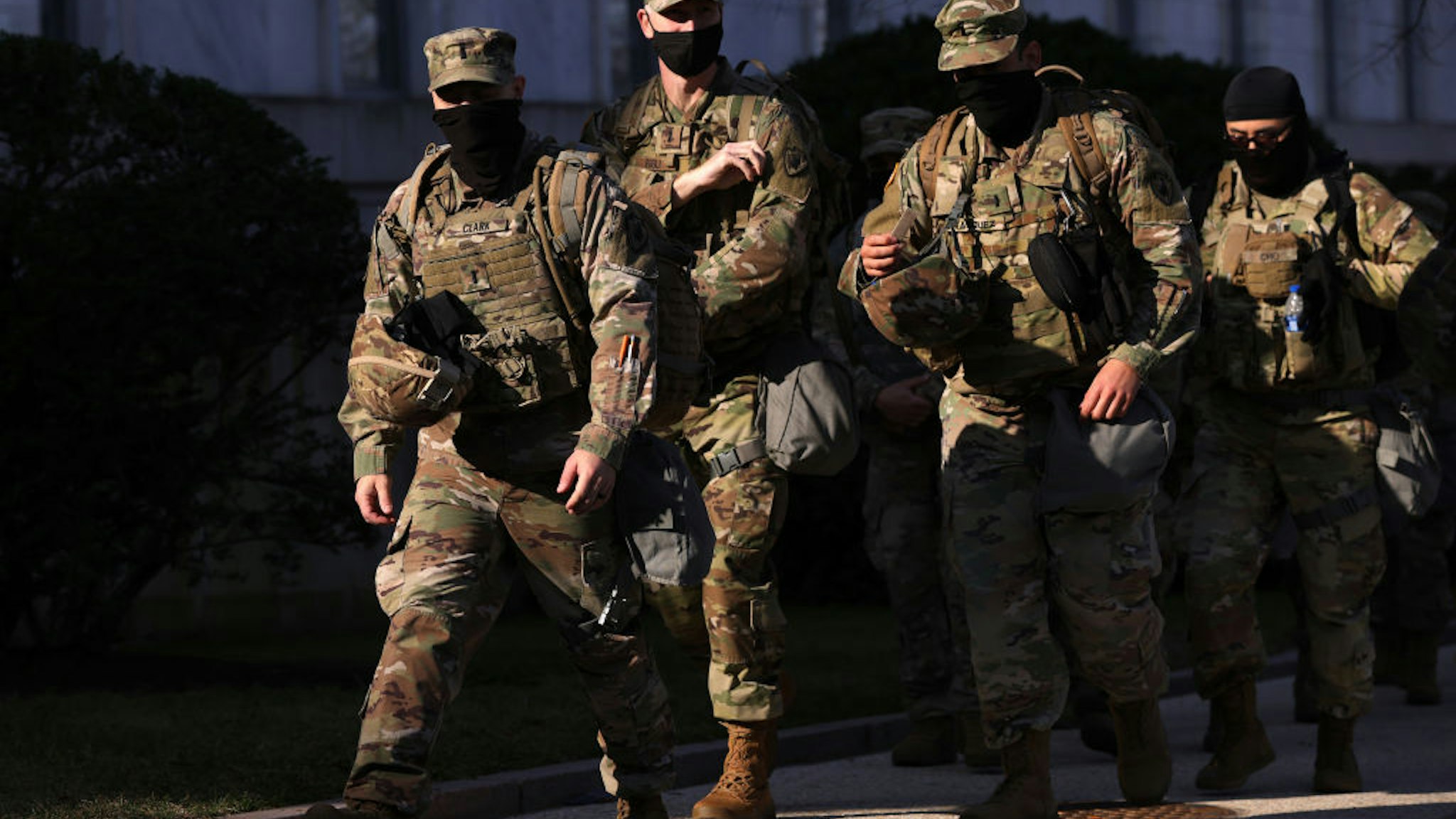 WASHINGTON, DC - MARCH 04: Members of the National Guard pass by Rayburn House Office Building on March 4, 2021 on Capitol Hill in Washington, DC. Security has been tightened up as intelligence obtained by U.S. Capitol Police showed a possible plot to breach the Capitol by an identified militia group on today, the date that QAnon followers believe that former U.S. President Donald Trump will return to power.
