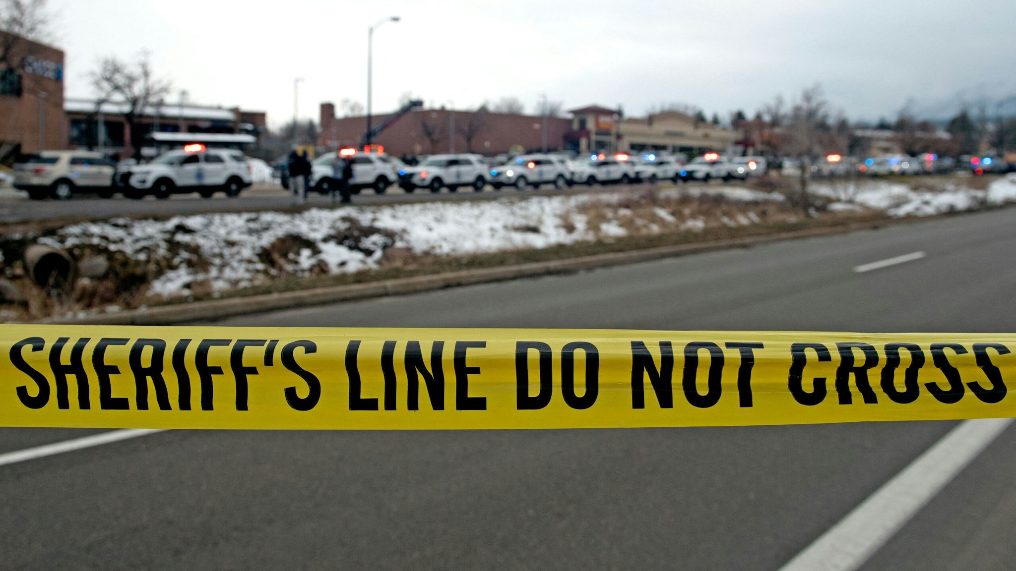 Crime scene tape closes off access to the King Soopers grocery store in Boulder, Colorado on March 22, 2021 after reports of an active shooter. - Police swarmed a grocery store in the western US state of Colorado on March 22, 2021, following reports of an active shooter and multiple casualties, law enforcement and eyewitnesses said, with at least one man detained. No details of casualties have been confirmed, but Colorado governor Jared Polis and Boulder Mayor Sam Weaver each referred to the incident as a "tragedy" in statements on Twitter.