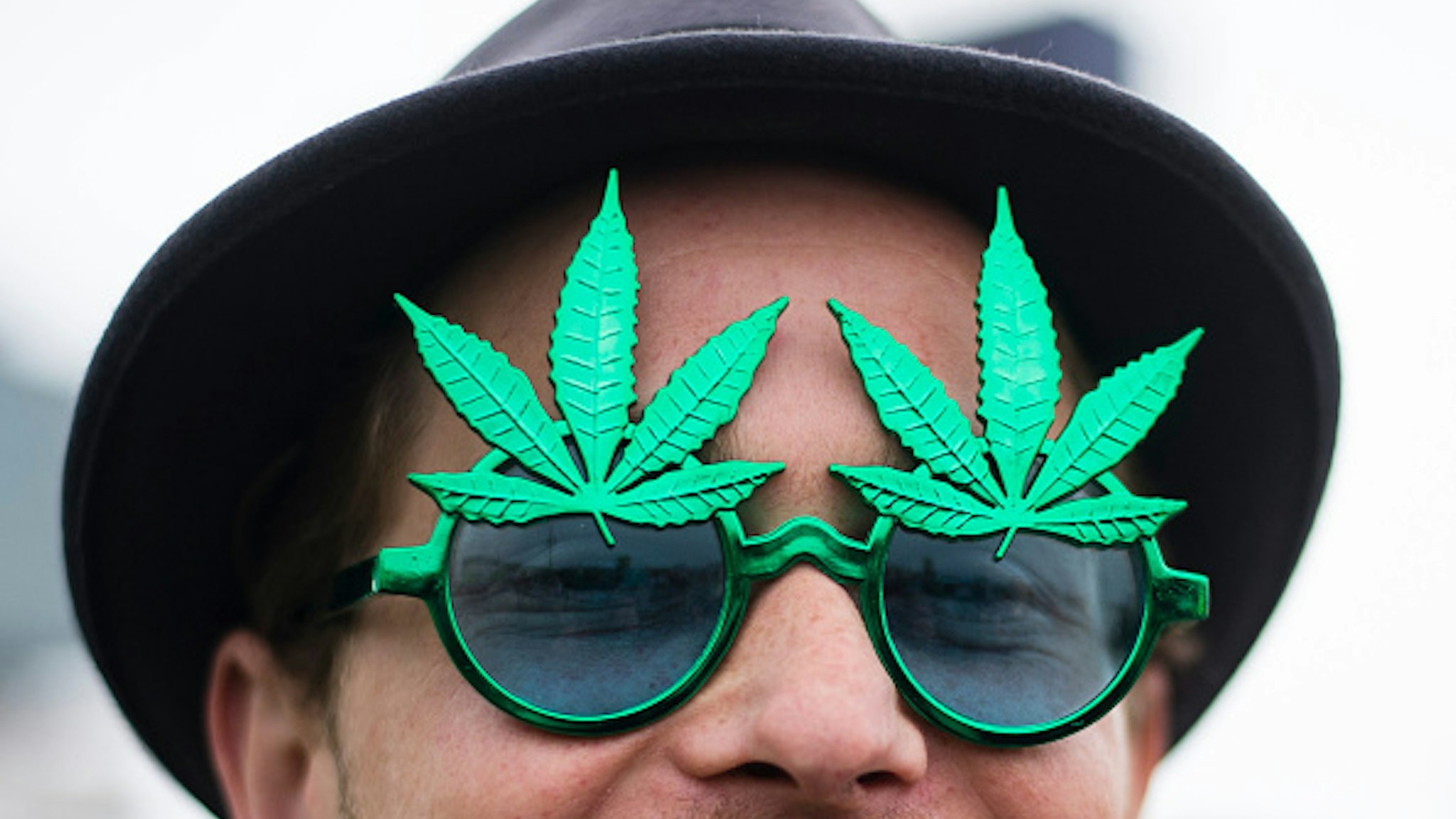 A demonstrator wears a pair of hemp glasses during a demonstration in favour of legalising cannabis in Berlin, Germany, 16 May 2015. The 'Global Marijuana March' is taking place with rallys worldwide. Photo: Gregor Fischer/dpa | usage worldwide