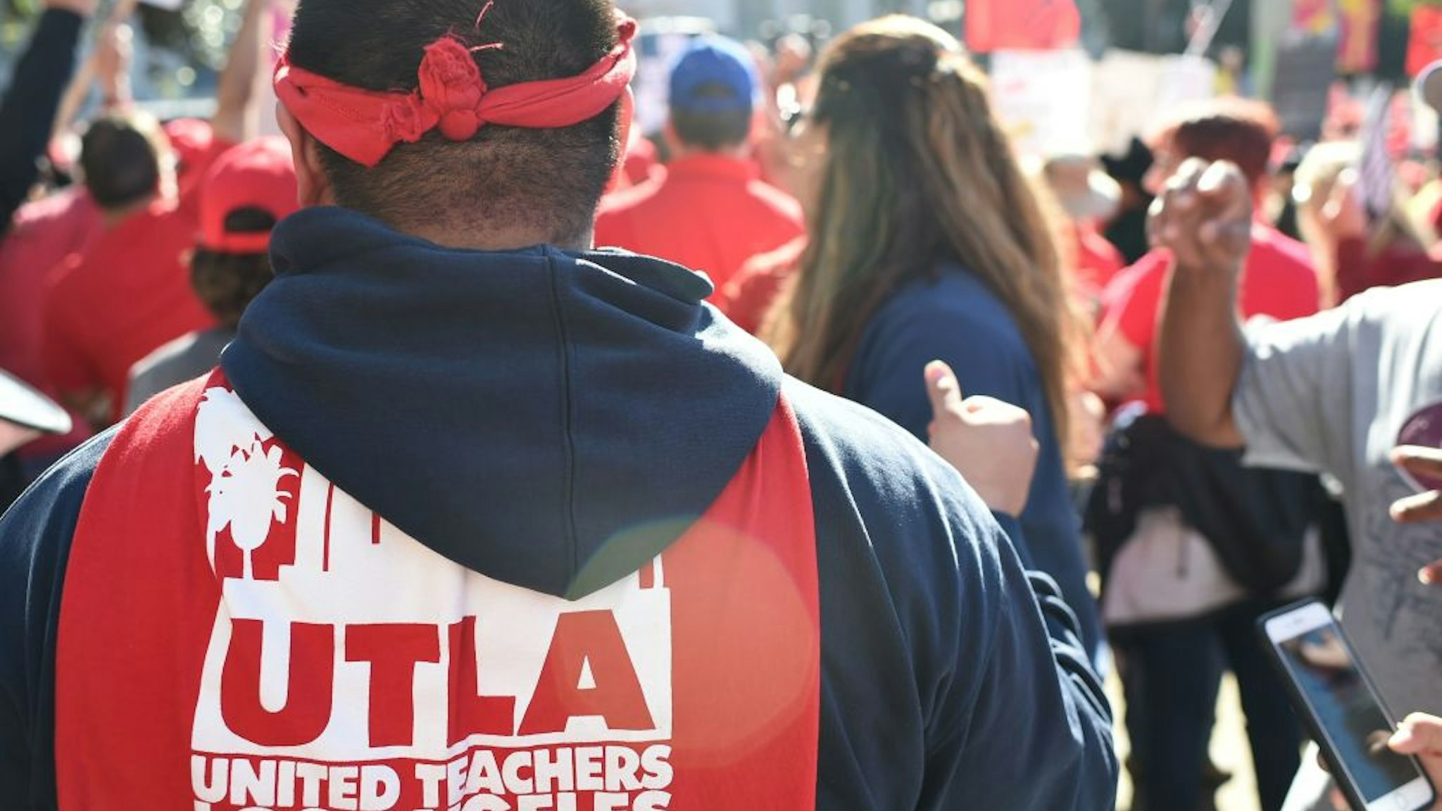 Striking teachers and supporters rally in Grand Park across from City Hall after the teacher's union reached a tentative deal with the Los Angeles Unified School District, on January 22, 2019 in Los Angles, California. - Union members have to vote on the agreement to end the strike which started on January 14.
