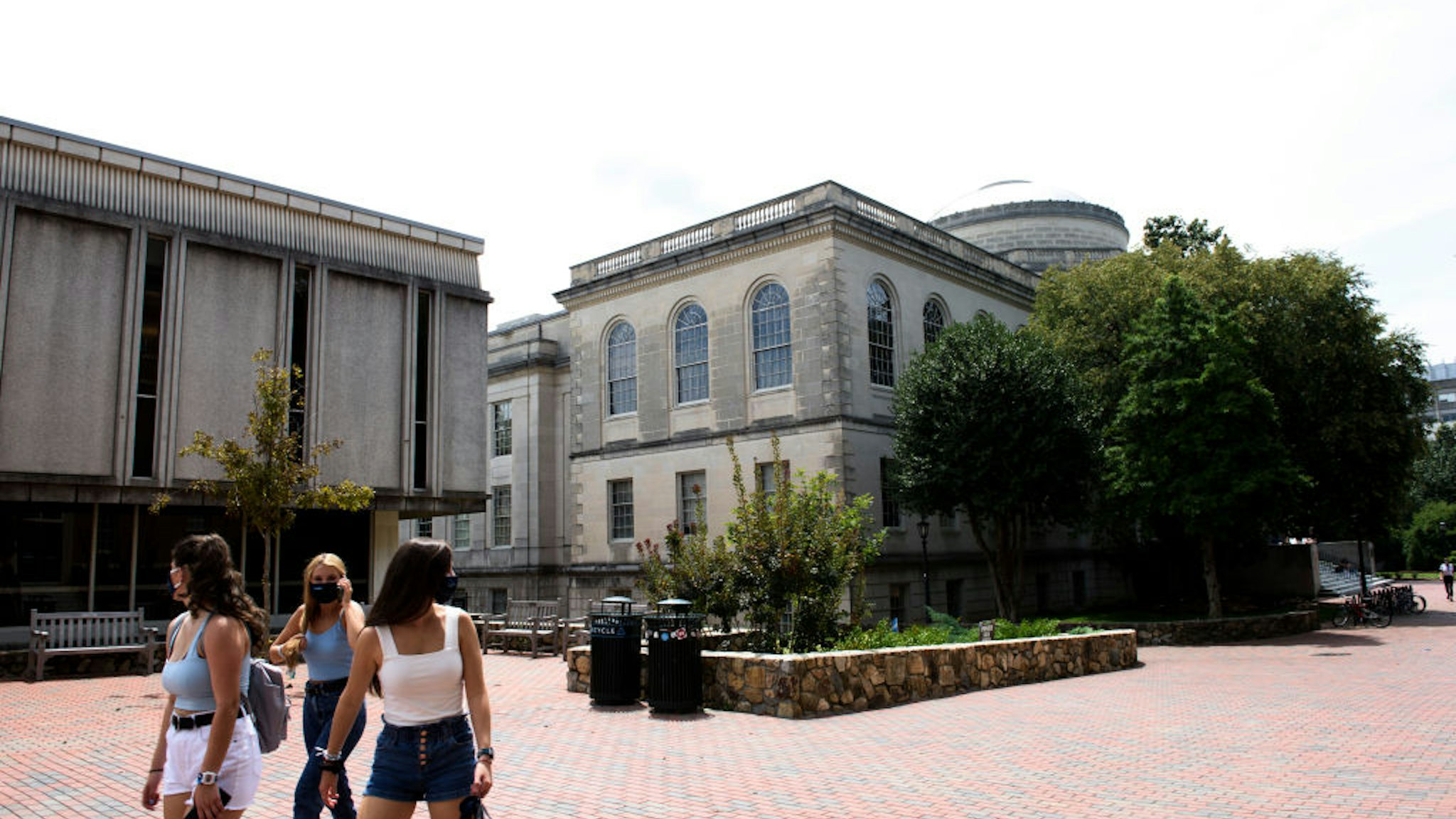 CHAPEL HILL, NC - AUGUST 18: Students walk through the campus of the University of North Carolina at Chapel Hill on August 18, 2020 in Chapel Hill, North Carolina. The school halted in-person classes and reverted back to online courses after a rise in the number of COVID-19 cases over the past week.