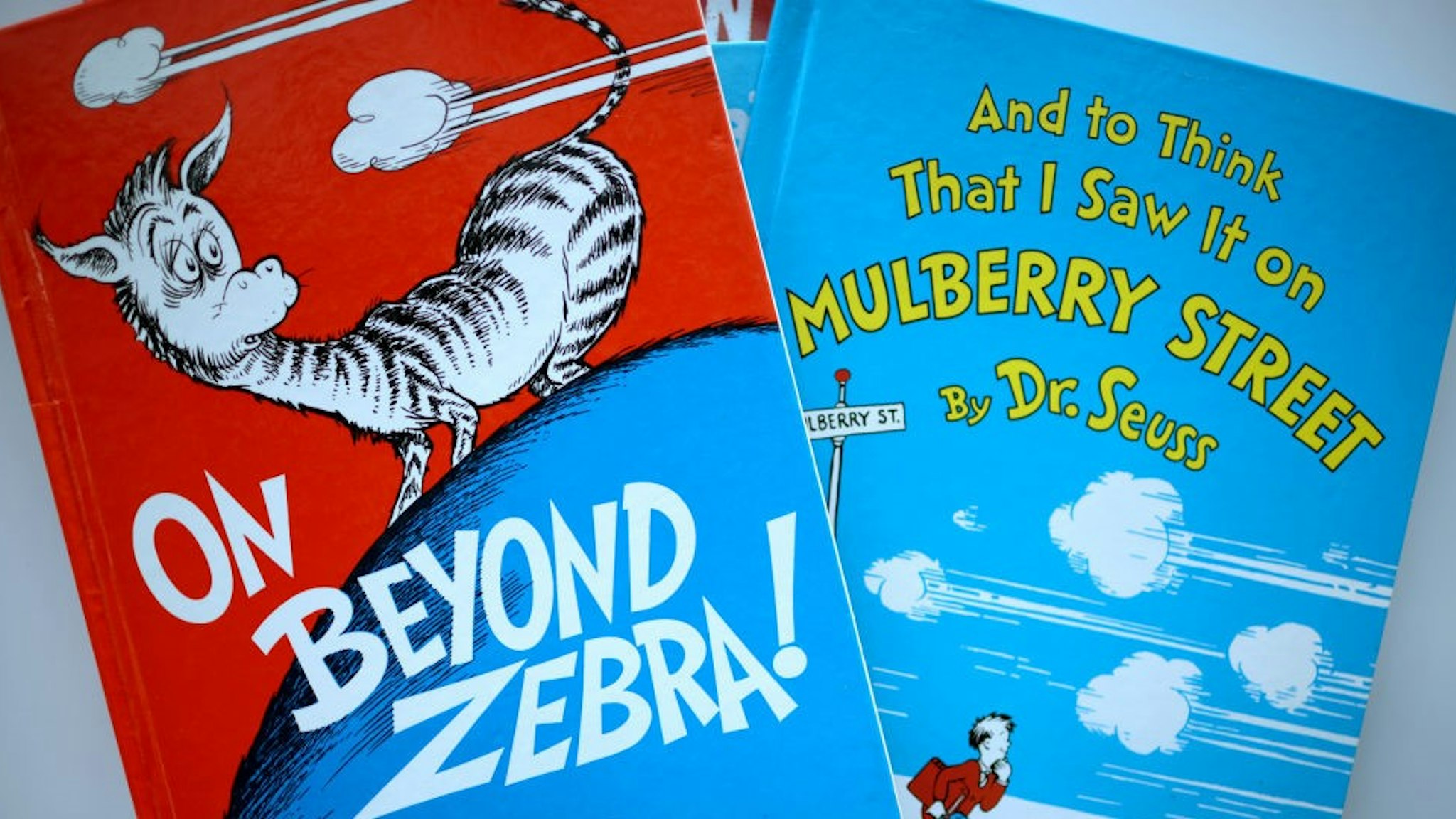 CHICAGO, ILLINOIS - MARCH 02: Books by Theodor Seuss Geisel, aka Dr. Seuss, including "On Beyond Zebra!" and "And to Think That I Saw it on Mulberry Street," are offered for loan at the Chinatown Branch of the Chicago Public Library on March 02, 2021 in Chicago, Illinois. The two titles are among six by the famed children's book author that will no longer be printed due to accusations of racist and insensitive imagery. The other titles include “If I Ran the Zoo,” “McElligot’s Pool,” “Scrambled Eggs Super!” and “The Cat’s Quizzer.” (Photo Illustration by