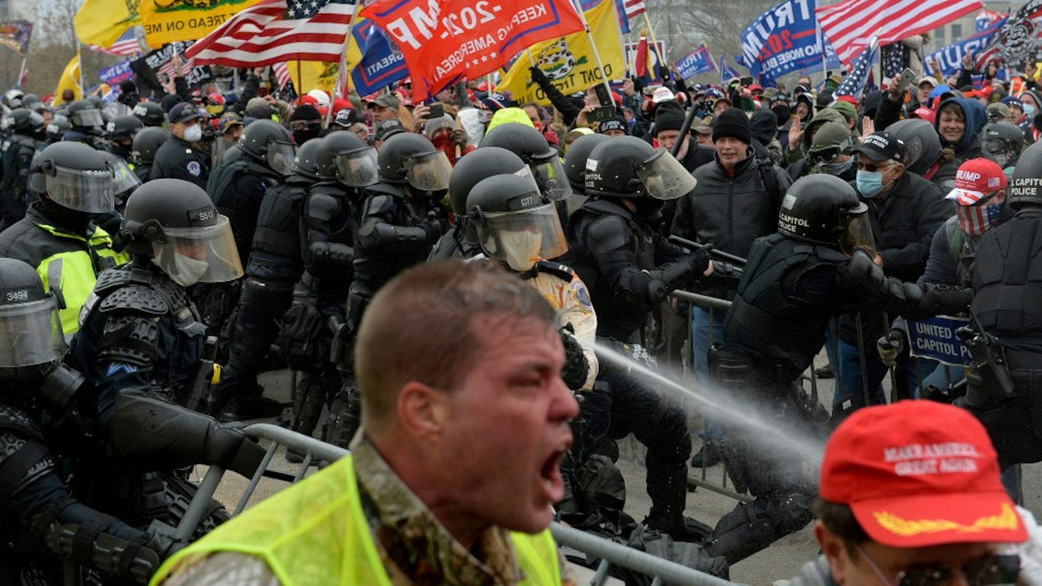 TOPSHOT - Trump supporters clash with police and security forces as people try to storm the US Capitol in Washington D.C on January 6, 2021. - Demonstrators breeched security and entered the Capitol as Congress debated the a 2020 presidential election Electoral Vote Certification. (Photo by Joseph Prezioso / AFP) (Photo by
