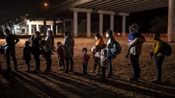 Migrants begin to arrive in growing numbers at border MISSION, TX- FEB 10: Migrants await processing after being apprehended at the U.S. border near Mission, Texas on Wednesday, Feb. 10, 2021. Various police departments from around the McAllen area assisted in apprehending unauthorized migrants. Nearly 100 migrants were apprehended in a span of about an hour.