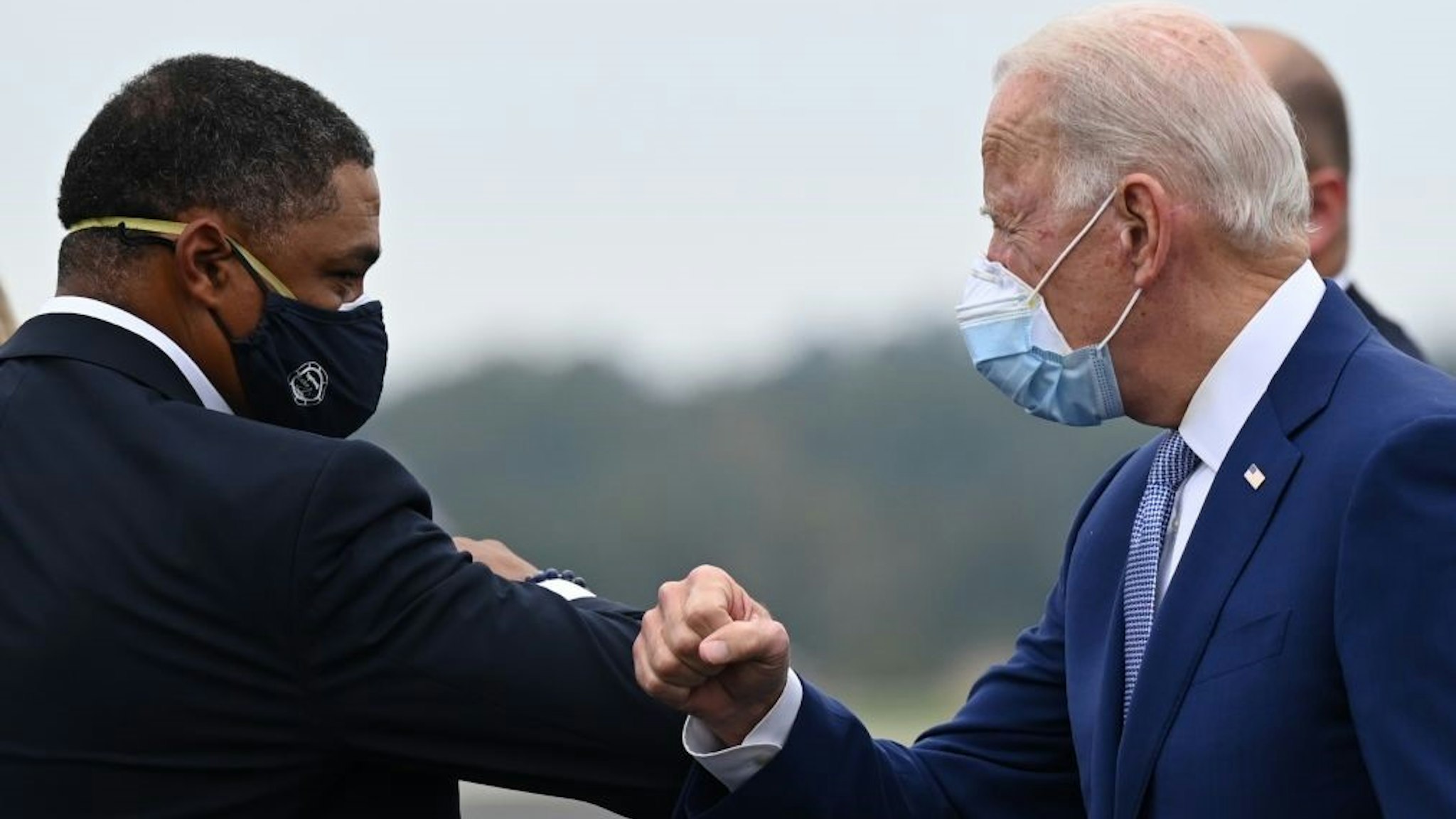 Democratic presidential candidate Joe Biden is greeted by US Congressman Cedric Richmond, D-LA as he arrives in Columbus, Georgia, on October 27, 2020. (Photo by JIM WATSON / AFP) (Photo by