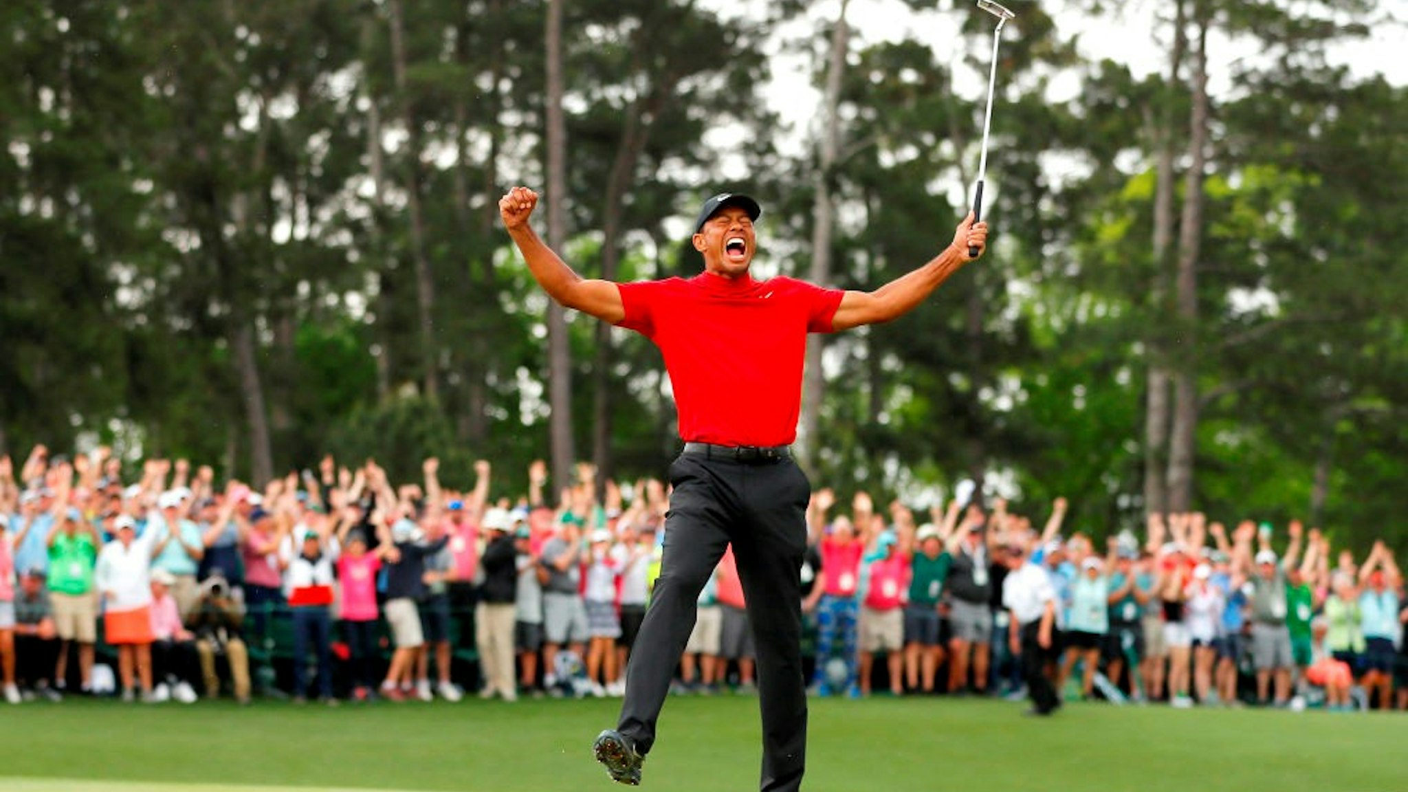 AUGUSTA, GEORGIA - APRIL 14: Tiger Woods of the United States celebrates after sinking his putt on the 18th green to win during the final round of the Masters at Augusta National Golf Club on April 14, 2019 in Augusta, Georgia. (Photo by