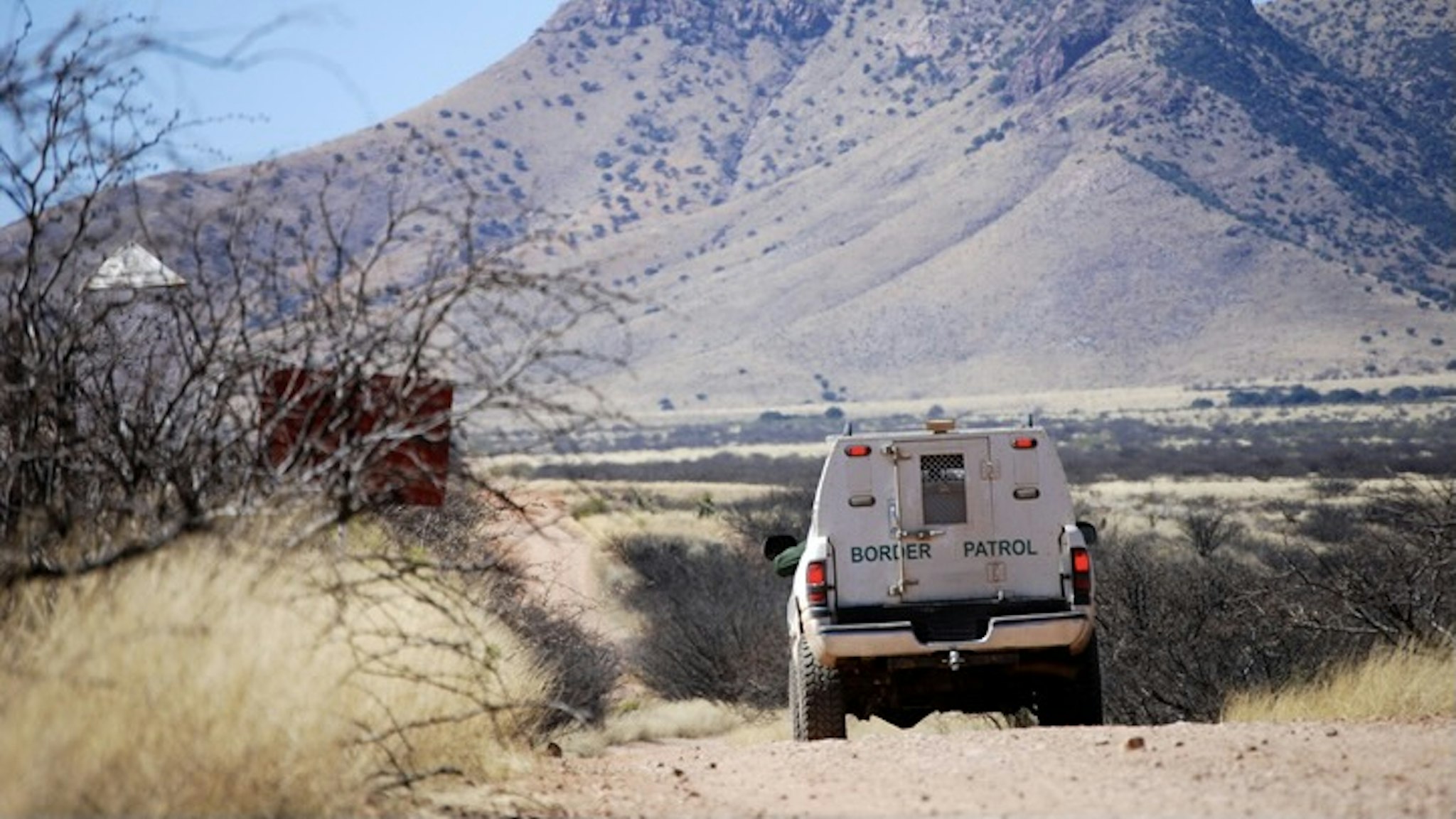 Border patrol truck with mountains - stock photo