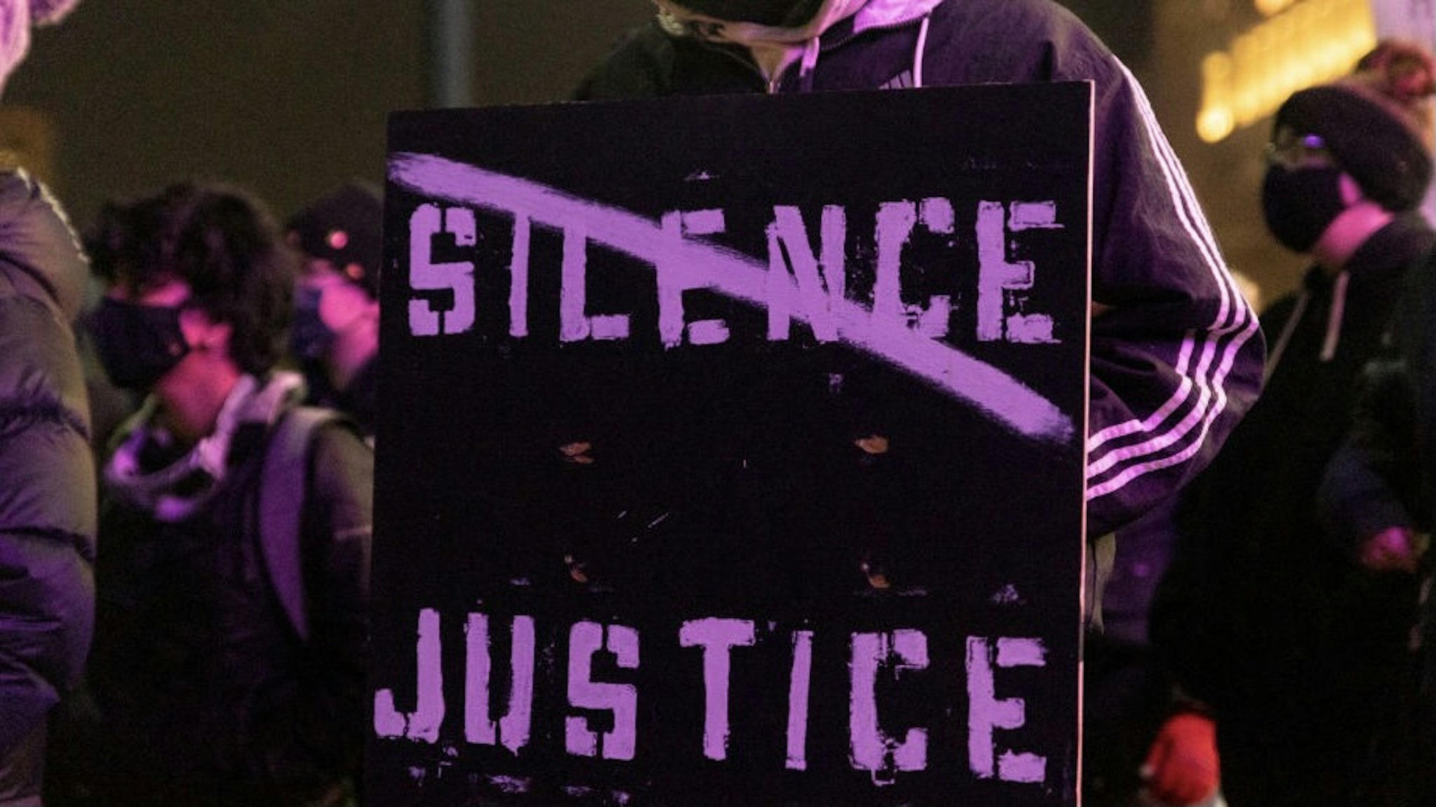 COLUMBUS, OH - APRIL 21: Black Lives Matter activist holds a sign against passivity in reaction to the police shooting of MaKhia Bryant on April 21, 2021 in Columbus, Ohio. Black Lives Matter activists met at Columbus Police Headquarters, marched to the Ohio Supreme Court and then to the Ohio Statehouse to protest the killing of Bryant on April 20th. (Photo by Stephen Zenner/Getty Images)