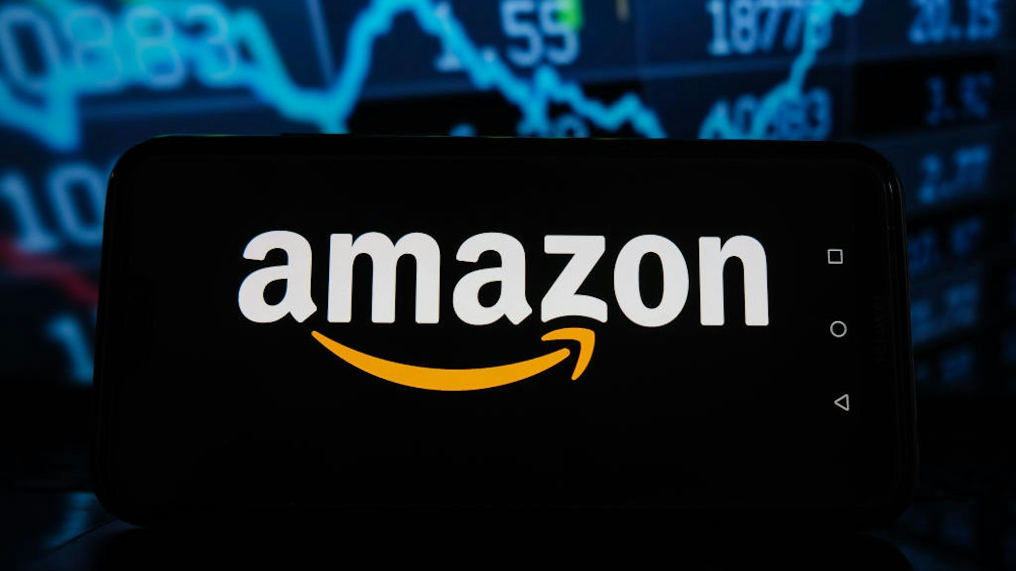 POLAND - 2021/04/08: In this photo illustration an Amazon logo seen displayed on a smartphone with stock market percentages in the background. (Photo Illustration by Omar Marques/SOPA Images/LightRocket via Getty Images)