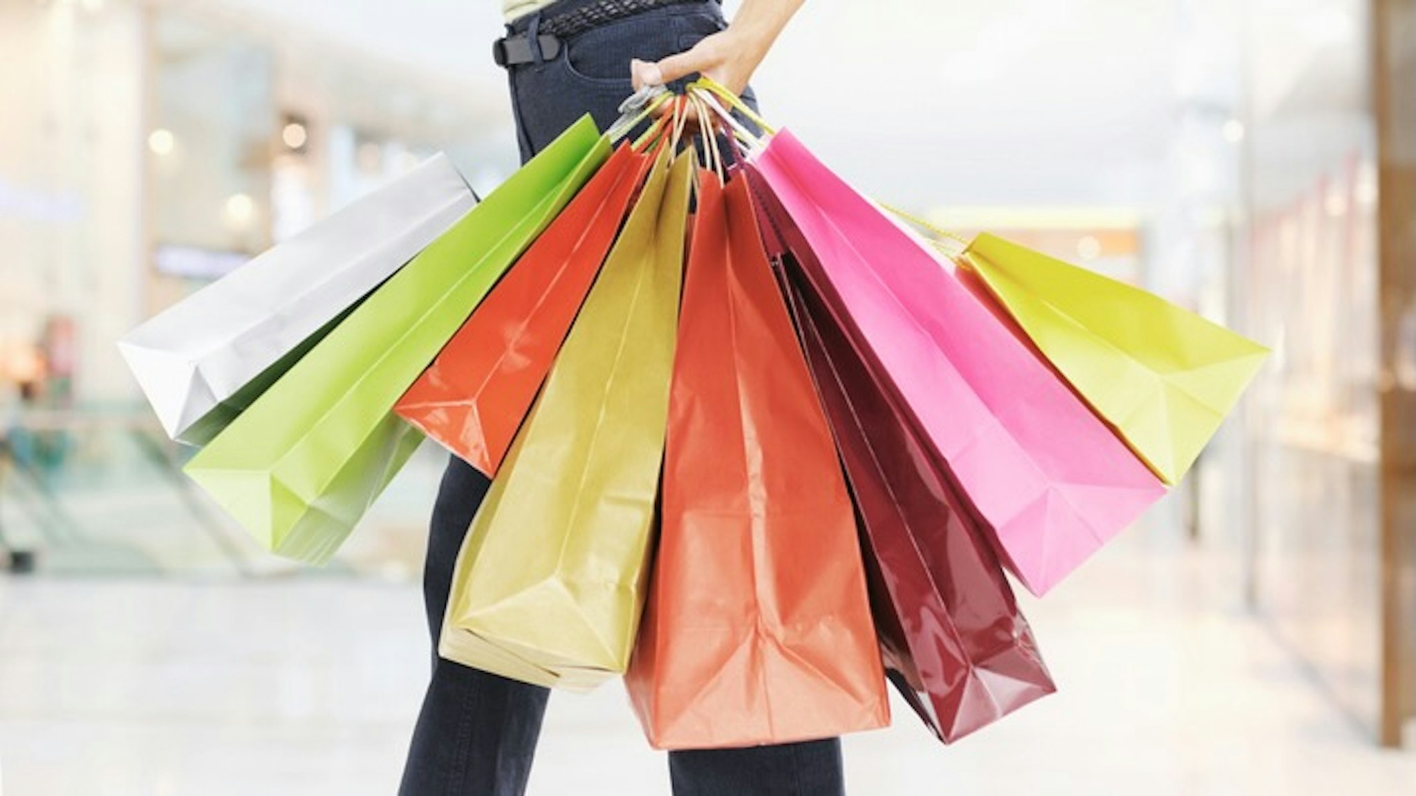 Woman carrying shopping bags - stock photo
