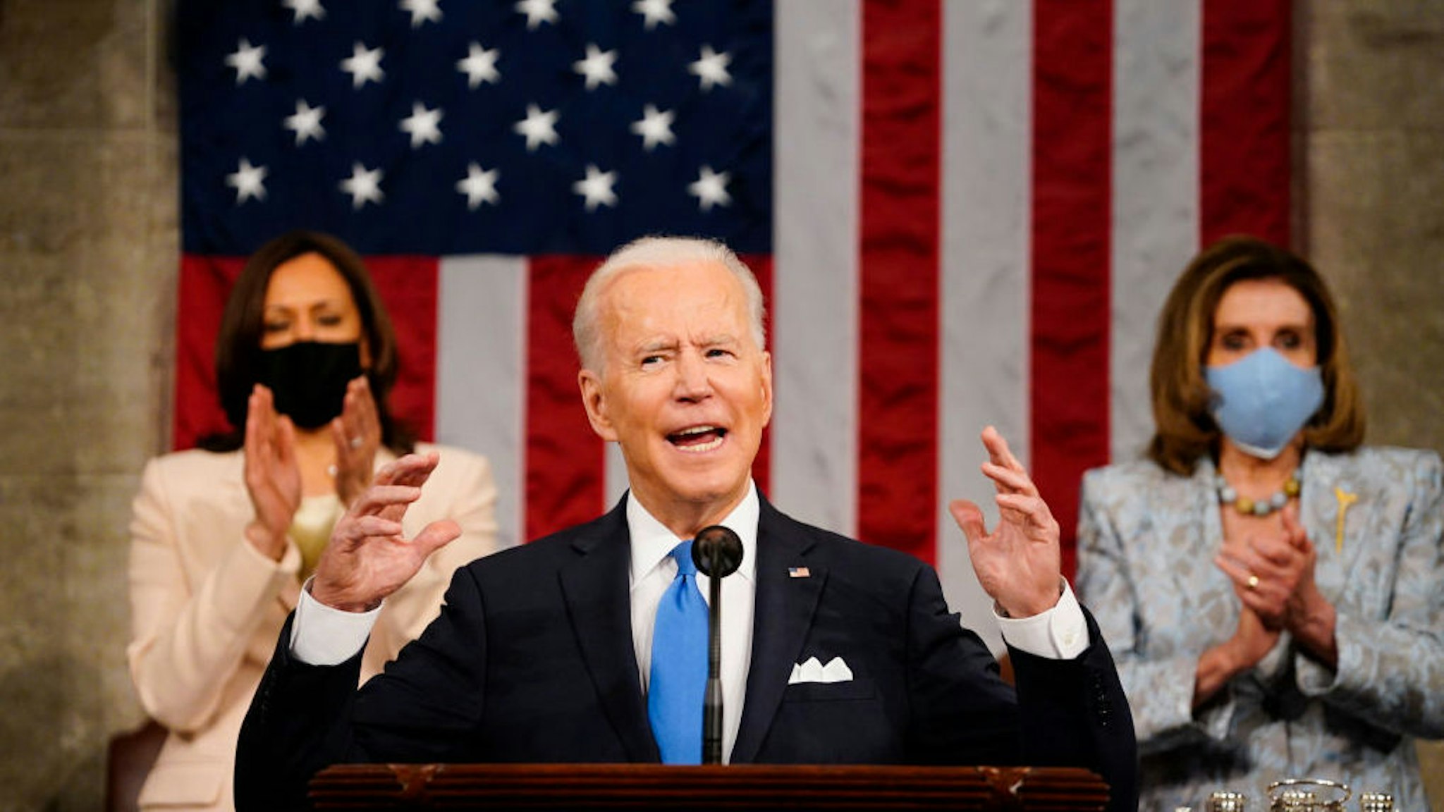 WASHINGTON, DC - APRIL 28: President Joe Biden addresses a joint session of Congress, with Vice President Kamala Harris and House Speaker Nancy Pelosi (D-CA) on the dais behind him on April 28, 2021 in Washington, DC. On the eve of his 100th day in office, Biden spoke about his plan to revive America’s economy and health as it continues to recover from a devastating pandemic. He delivered his speech before 200 invited lawmakers and other government officials instead of the normal 1600 guests because of the ongoing COVID-19 pandemic.
