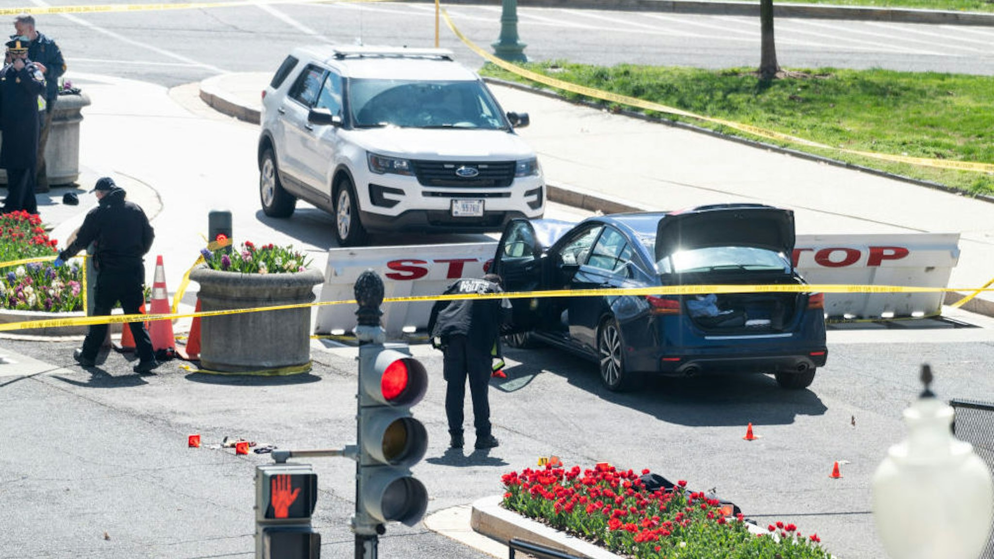 UNITED STATES - APRIL 2: Capitol Police investigate the scene after a vehicle drove into a security barrier near the U.S. Capitol building on Friday April 2, 2021. Two officers were reported injured with the driver of the vehicle fatally shot.