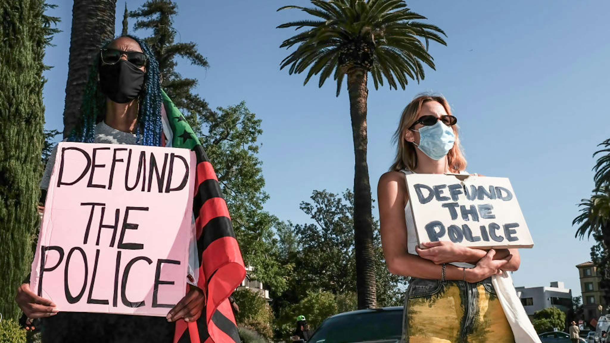 LOS ANGELES, CALIFORNIA, UNITED STATES - 2021/04/20: Protesters hold placards during the demonstration. Hours after the verdict of the Derek Chauvin trial, protesters meet outside of Los Angeles Mayor Eric Garcetti's home to protest his proposed funding of the Los Angeles Police Department.