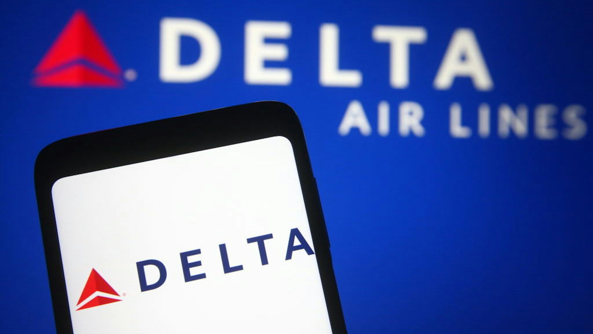 UKRAINE - 2021/03/21: In this photo illustration a Delta Air Lines logo is seen on a smartphone and a pc screen. (Photo Illustration by Pavlo Gonchar/SOPA Images/LightRocket via Getty Images)