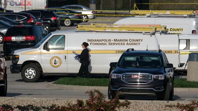 Marion County Forensic Services vehicles are parked at the site of a mass shooting at a FedEx facility in Indianapolis, Indiana on April 16, 2021. - At least eight people were killed at the facility late April 15 by a gunman, who is believed to have then turned the gun on himself, police in Indianapolis said. Four people with gunshot wounds were transported by ambulance, including one in critical condition, police said. Three were transported with other injuries, while two were treated at the scene and then released.