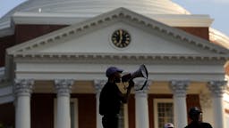 Charlottesville Marks First Anniversary Of Deadly Rally CHARLOTTESVILLE, VA - AUGUST 11: Protesters with the group Students Act Against White Supremacy speak on the campus of the University of Virginia during an event marking the one year anniversary of a deadly clash between white supremacists and counter protesters August 11, 2018 in Charlottesville, Virginia. Charlottesville has been declared in a state of emergency by Virginia Gov. Ralph Northam as the city braces for the one year anniversary of the deadly clash between white supremacist forces and counter protesters over the potential removal of Confederate statues of Robert E. Lee and Stonewall Jackson. A ÒUnite the RightÓ rally featuring some of the same groups is planned for tomorrow in Washington, DC. (Photo by Win McNamee/Getty Images)
