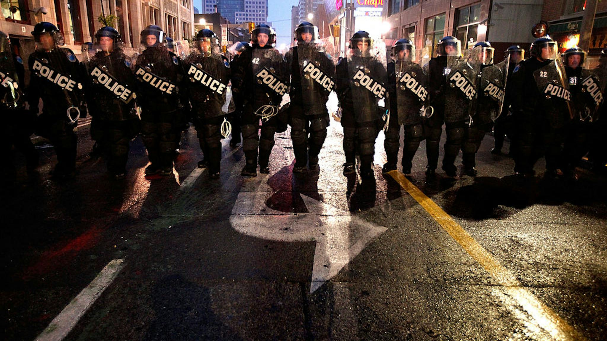 TORONTO, ON – JUNE 26: Police officers in full riot gear advance on anti-G20 demonstrators on Queen Street June 26, 2010 in Toronto, Canada. Earlier in the day violent protesters burned police cars, smashed shop fronts and confronted the force of approximately 20,000 police charged with keeping order during the first day of the G20 Summit TORONTO, ON - JUNE 26: Police officers in full riot gear advance on anti-G20 demonstrators on Queen Street June 26, 2010 in Toronto, Canada. Earlier in the day violent protesters burned police cars, smashed shop fronts and confronted the force of approximately 20,000 police charged with keeping order during the first day of the G20 Summit