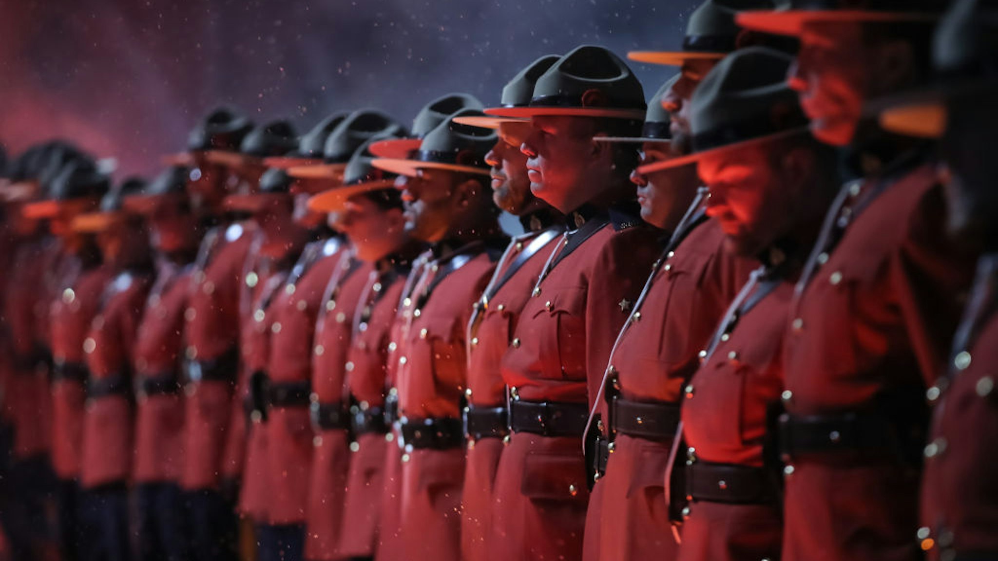 Uniformed Royal Canadian Mounted Police officers line up in a Wall of Honour before the Calgary Flames take on the Winnipeg Jets during the 2019 Tim Hortons NHL Heritage Classic at Mosaic Stadium on October 26, 2019 in Regina, Saskatchewan, Canada