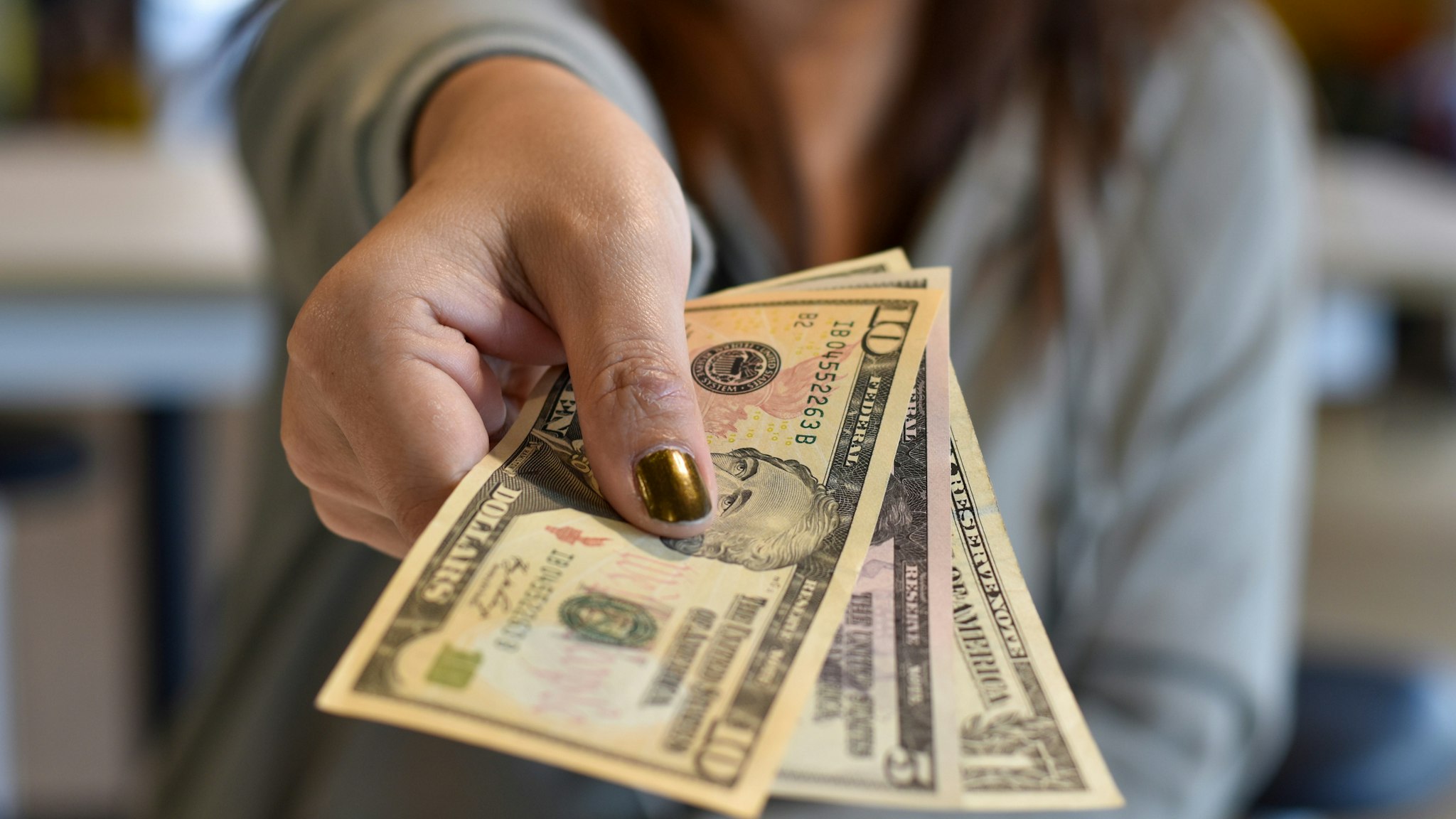 Midsection Of Woman Giving Paper Currency - stock photo