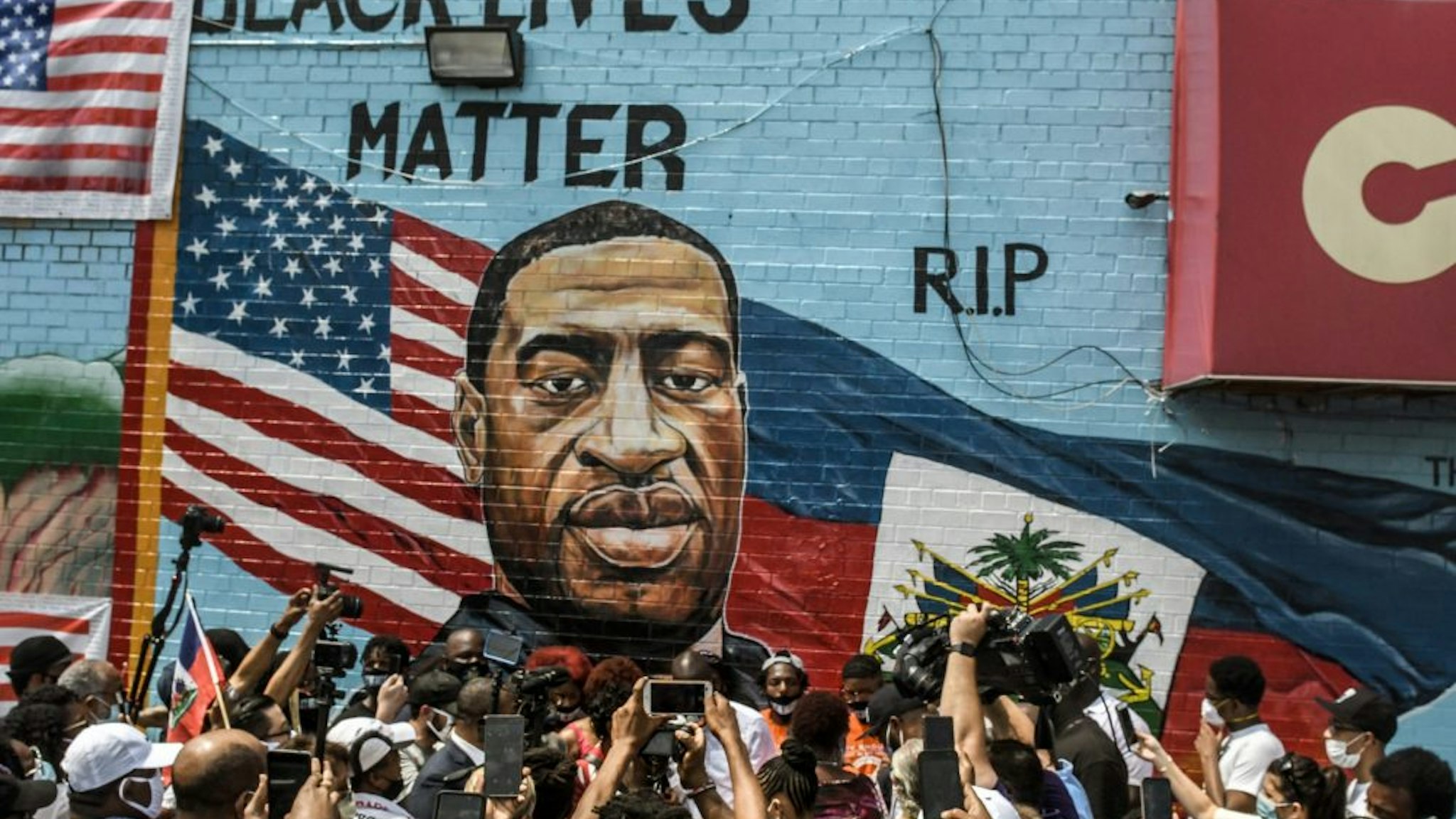 NEW YORK, NY - JULY 13: A mural painted by artist Kenny Altidor depicting George Floyd is unveiled on a sidewall of CTown Supermarket on July 13, 2020 in the Brooklyn borough New York City. George Floyd was killed by a white police officer in Minneapolis and his death has sparked a national reckoning about race and policing in the United States.
