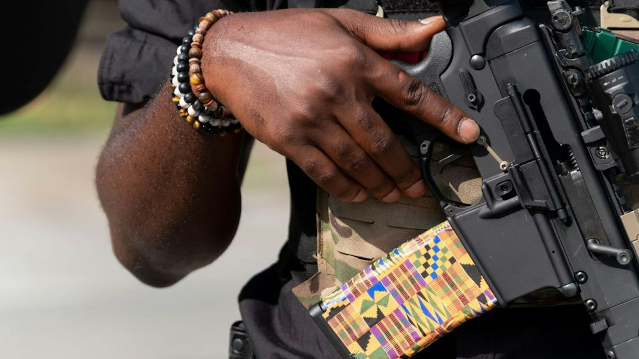 EDITORS NOTE: Graphic content / A member of the "Not Fucking Around Coalition" (NFAC), an all Black militia, holds a weapon during a rally to protest the killing of Breonna Taylor, in Louisville, Kentucky on July 25, 2020.