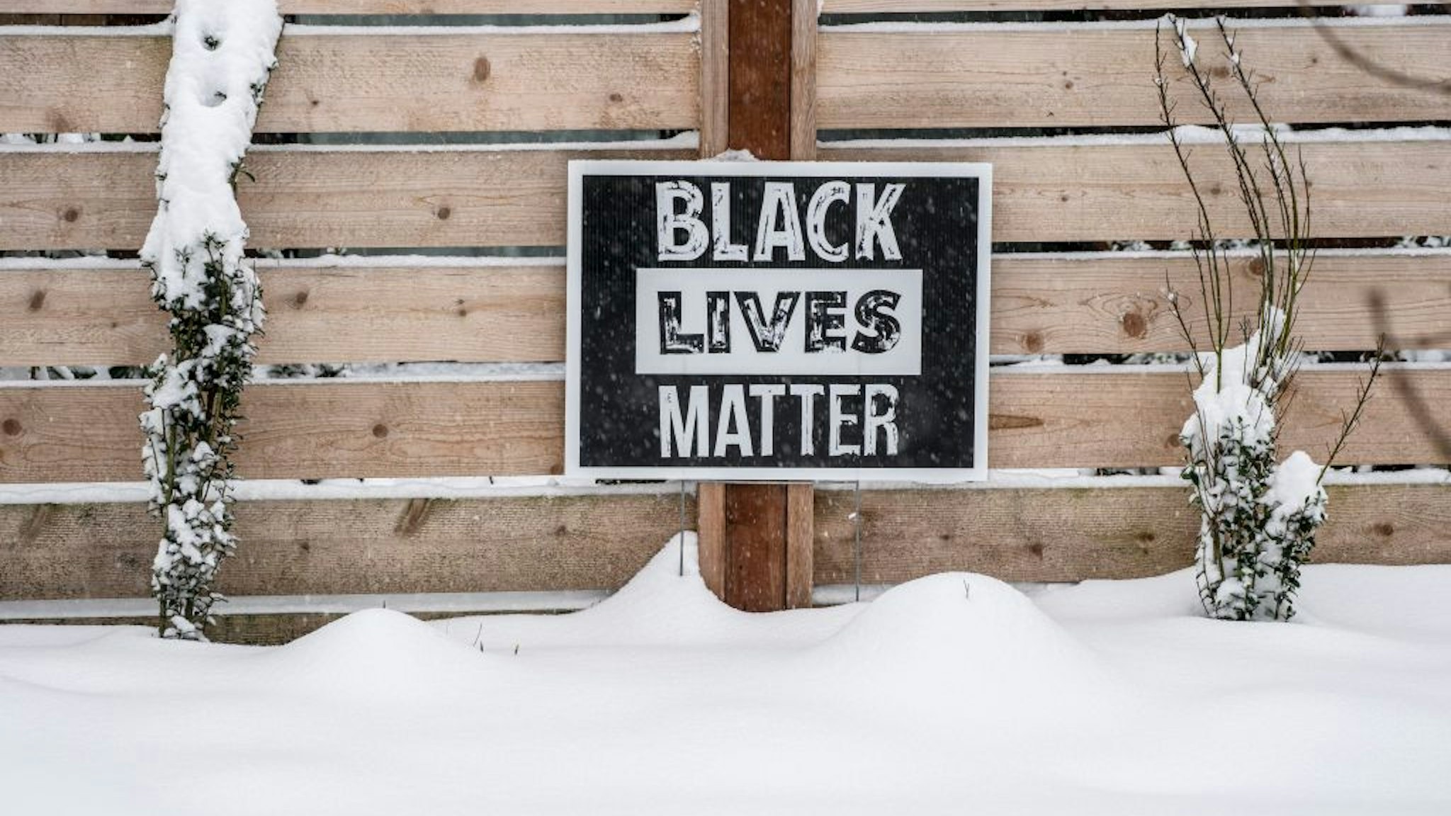 A Black Lives Matter sign sits in the snow outside of a home on February 13, 2021 in Seattle, Washington.
