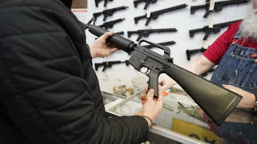 Gun Show A salesperson shows an AR-15 rifle to a customer at a store in Orem, Utah, U.S., on Thursday, March 25, 2021. Two mass shootings in one week are giving Democrats new urgency to pass gun control legislation, but opposition from Republicans in the Senate remains the biggest obstacle to any breakthrough in the long-stalled debate.