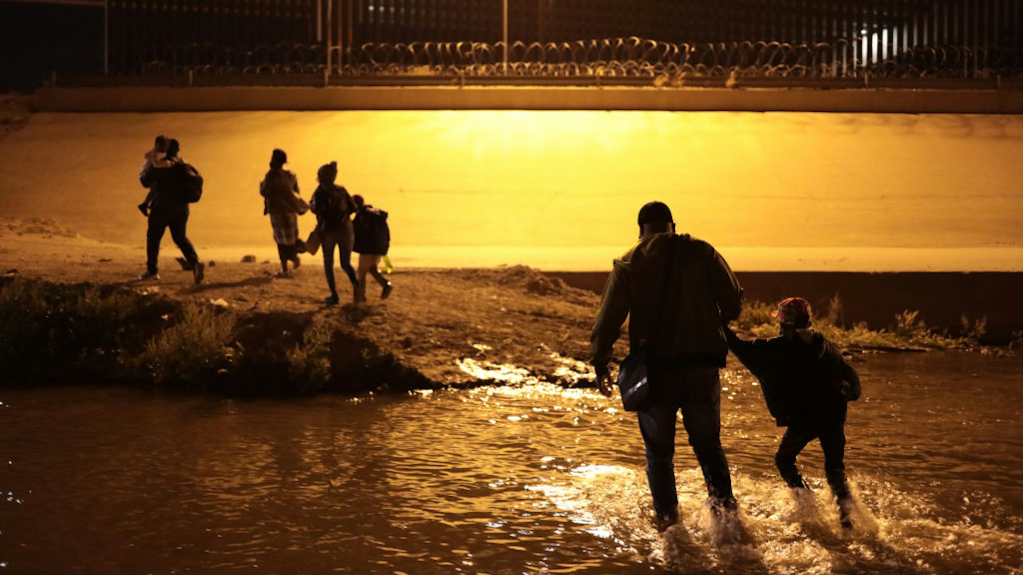 A family from Haiti crosses the Rio Grande, Juarez, Mexico, on March 30, 2021 to surrender to the border patrol to request political asylum in the United States, during the last month an increase in Haitian families has been seen crossing the border city Juarez El Paso Texas (Photo by David Peinado/NurPhoto via Getty Images)