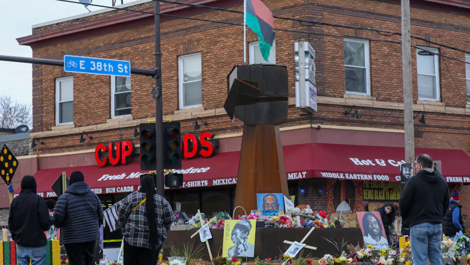 People lay flowers at a memorial in George Floyd Square MINNEAPOLIS, MINNESOTA - APRIL 21: People lay flowers at a memorial in George Floyd Square in Minneapolis, Minnesota, United States on April 21, 2021. George Floyd by the Cup Foods where he was killed by Minneapolis Police Officer Derek Chauvin in Minneapolis, Minnesota. (Photo by Yasin Ozturk/Anadolu Agency via Getty Images)