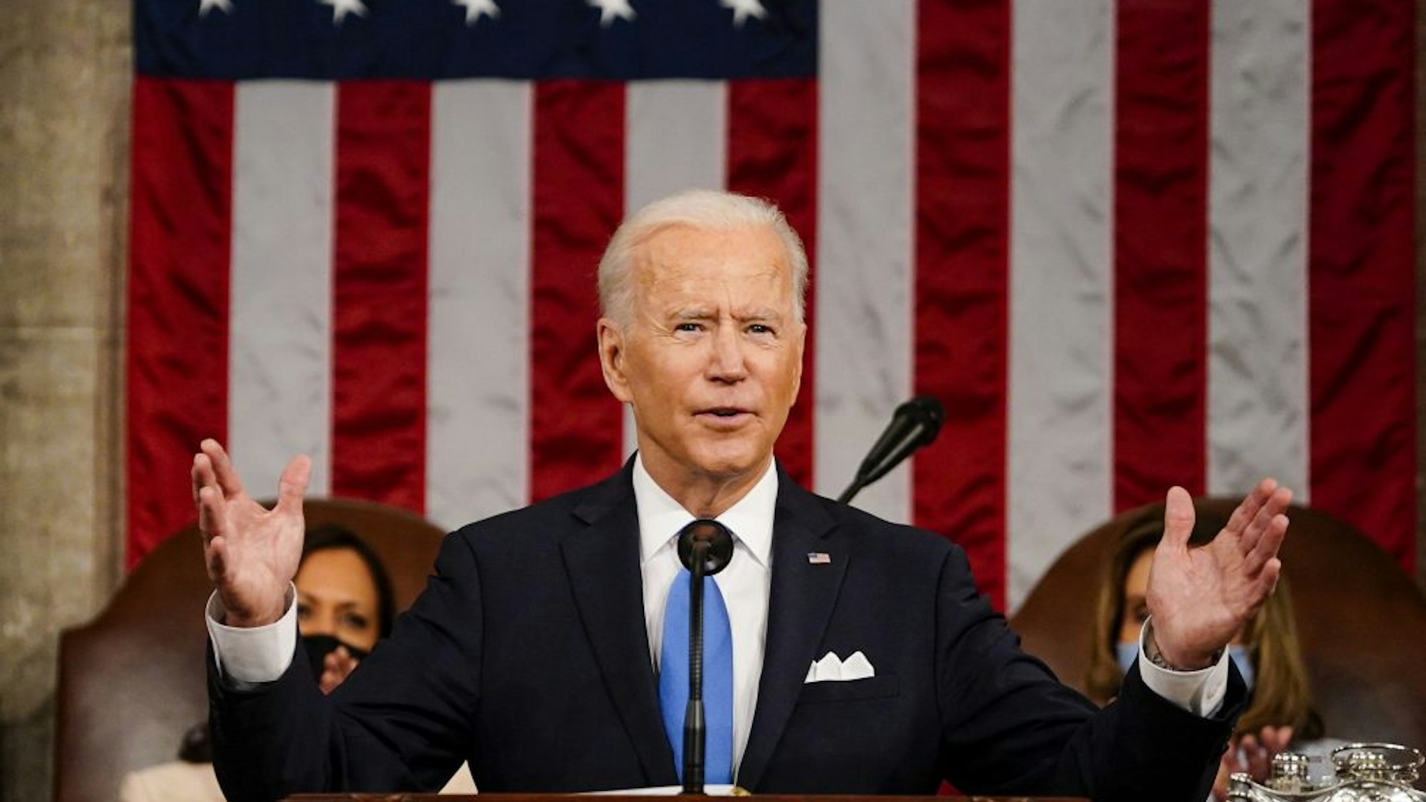 WASHINGTON, DC - APRIL 28: President Joe Biden addresses a joint session of Congress, with Vice President Kamala Harris and House Speaker Nancy Pelosi (D-Calif.) on the dais behind him, on Wednesday, April 28, 2021. Biden spoke to a nation seeking to emerge from twin crises of pandemic and economic slide in his first speech to a joint session of Congress.