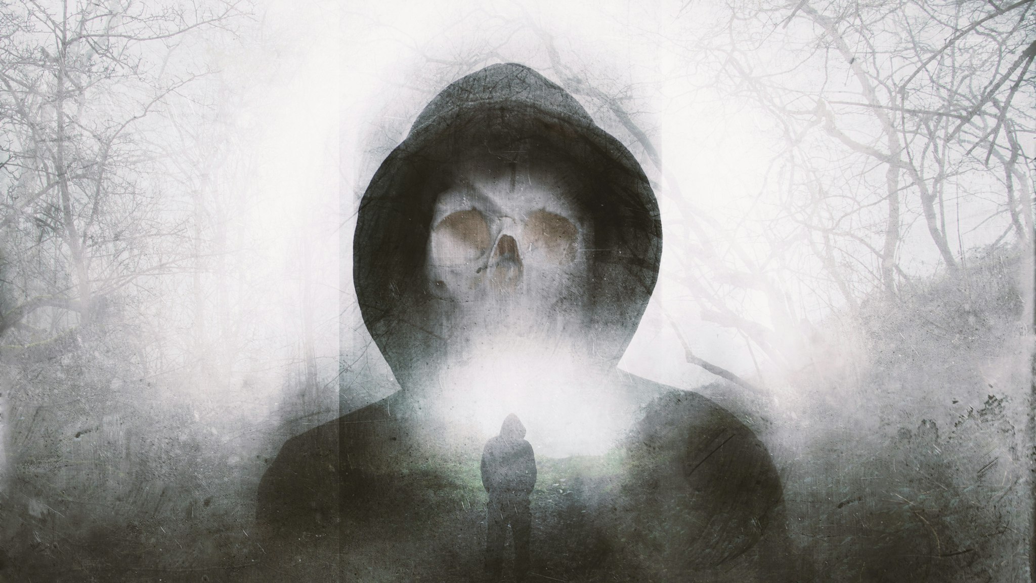 A double exposure of a scary hooded figure with a skull for a face. Over layered with a forest in winter. with a blurred, grunge, abstract edit - stock photo