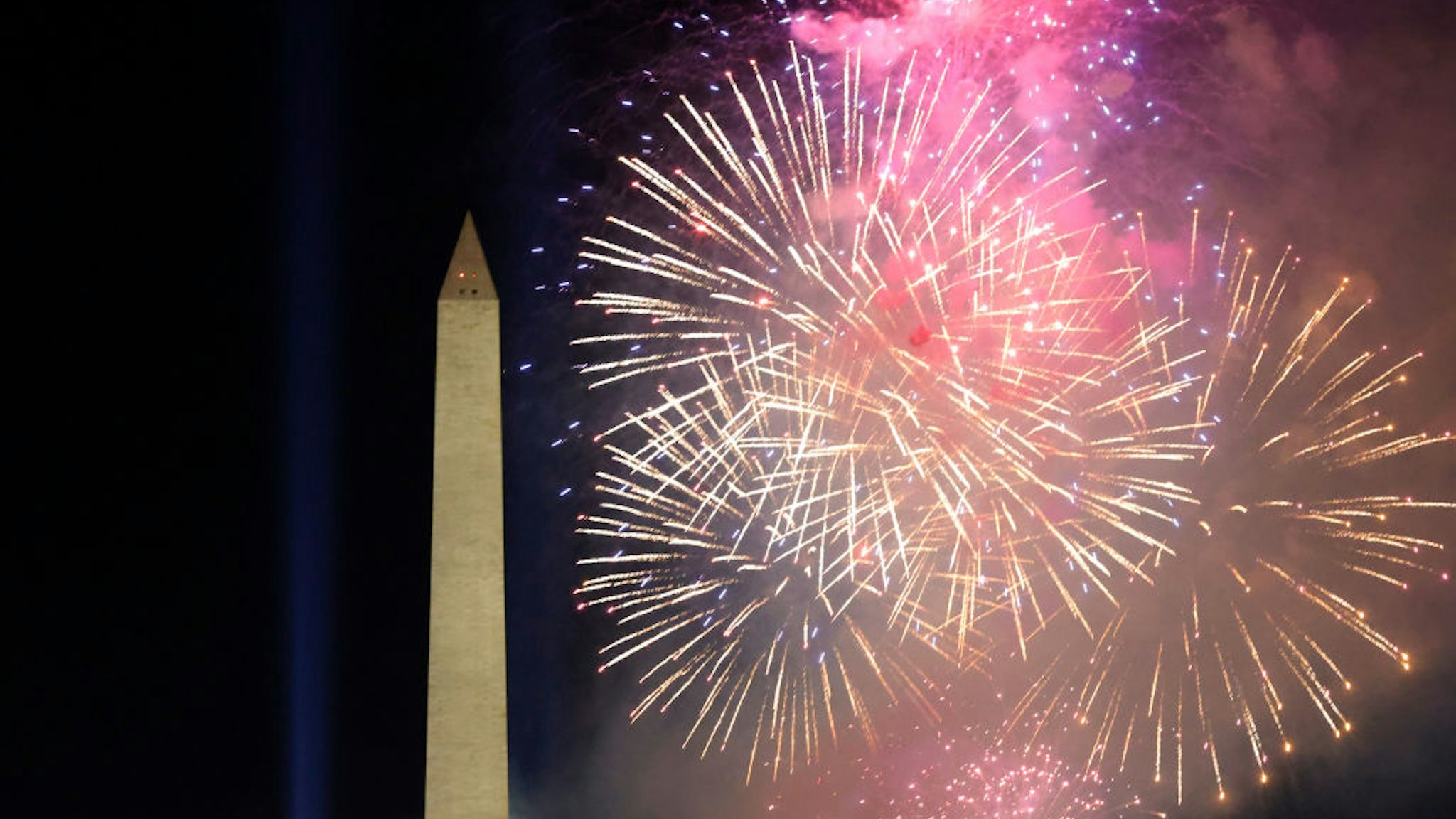 WASHINGTON, DC - JANUARY 20: Fireworks detonate about the Washington Monument during an Inauguration Day event at the Lincoln Memorial on January 20, 2021 in Washington, DC. President Joe Biden and Vice President Kamala Harris were sworn in today. (Photo by Justin Sullivan/Getty Images)